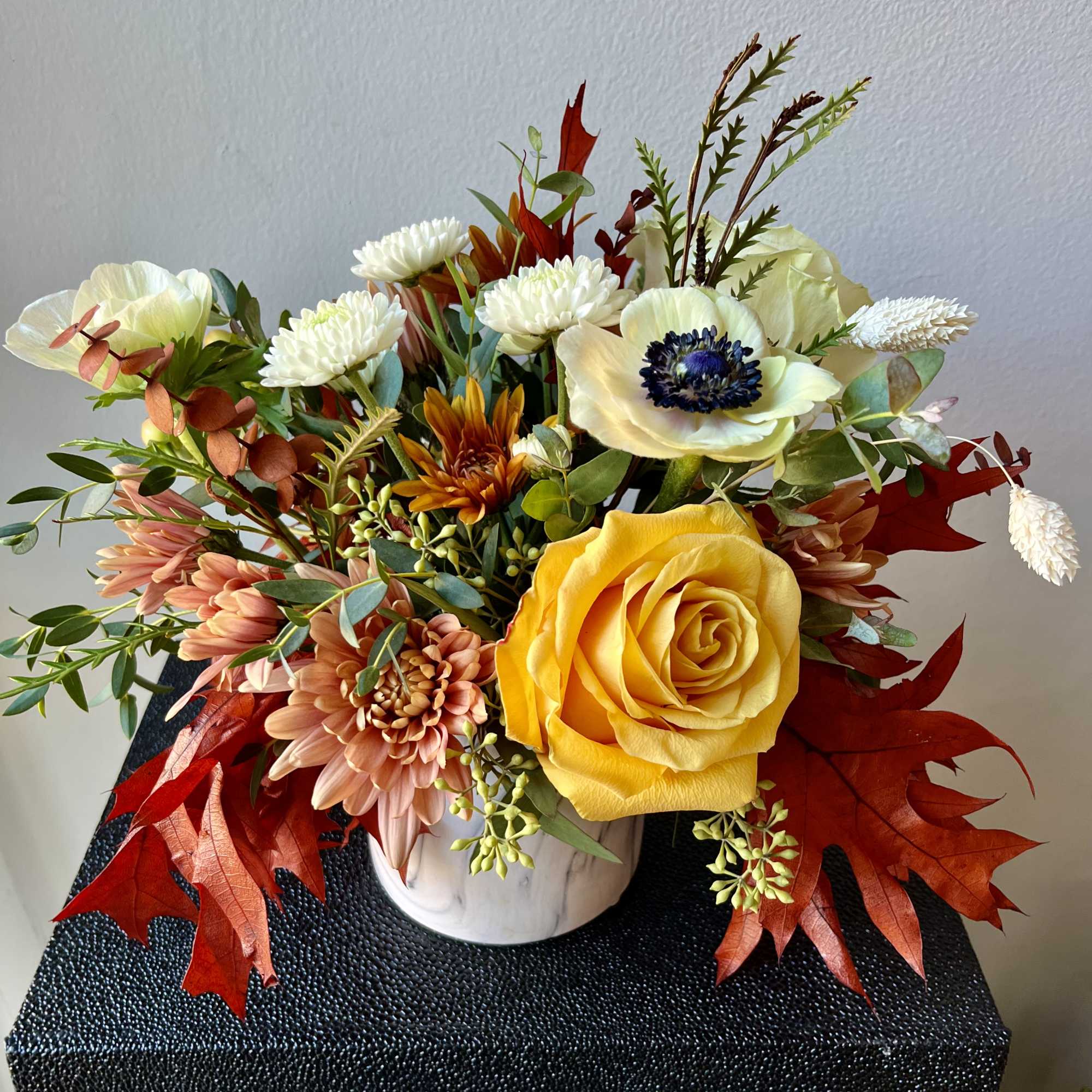 SMALL Low Premium Arrangement in 4&rdquo; white ceramic marble cylinder with muted