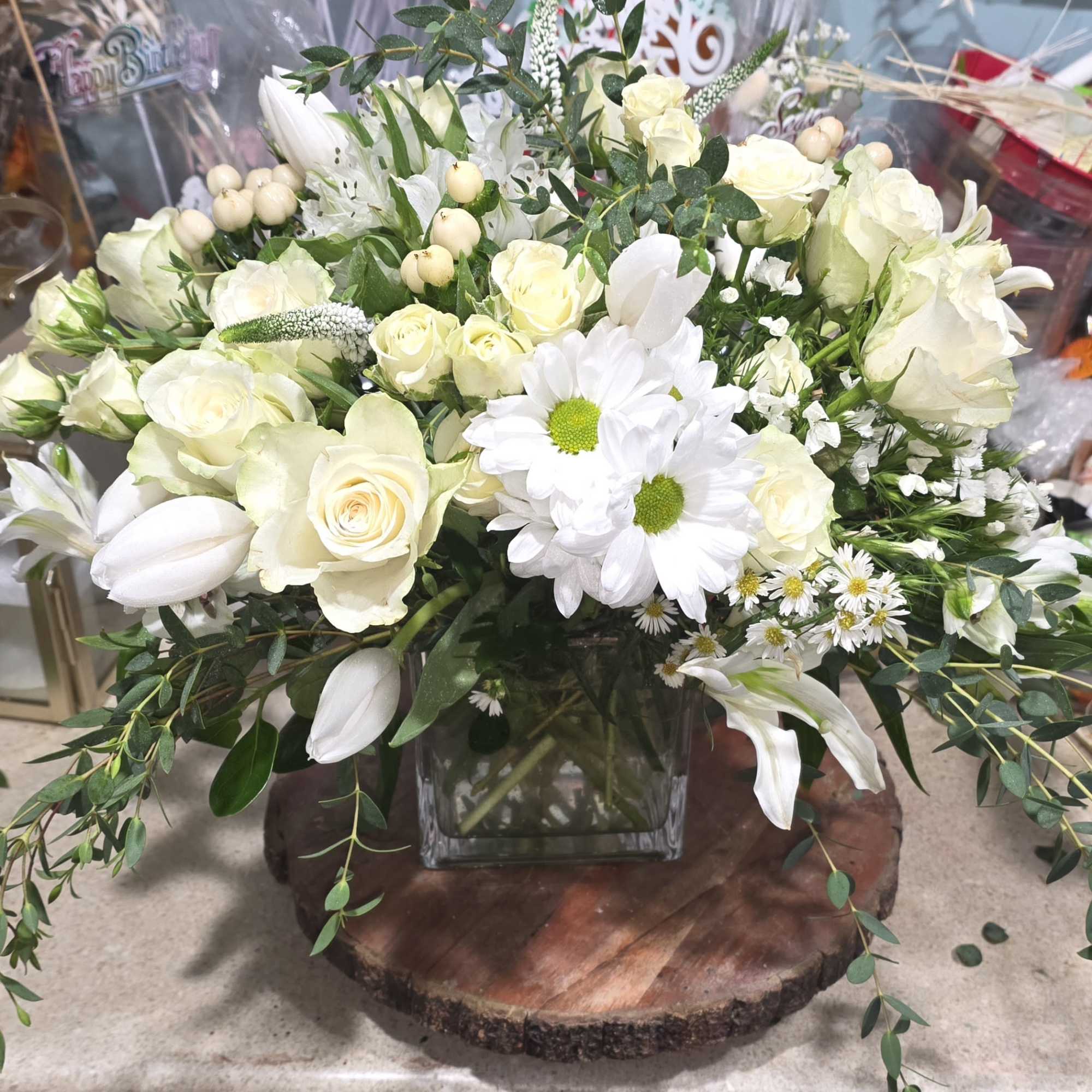 Beautiful all white arrangement. Can be sent as a sympathy gift or