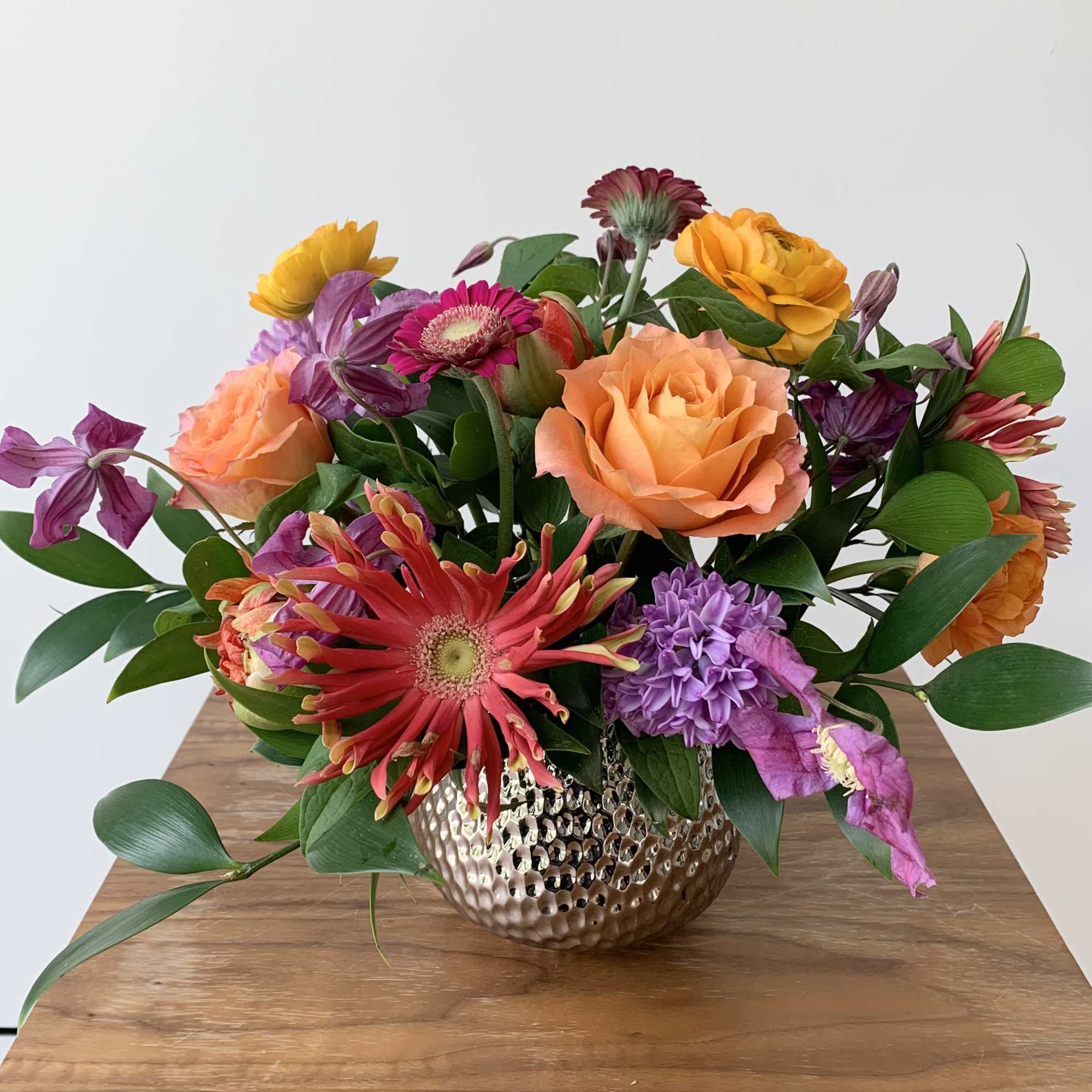 Cute colorful flower arrangement of premium flowers in a silver Supernova Pot