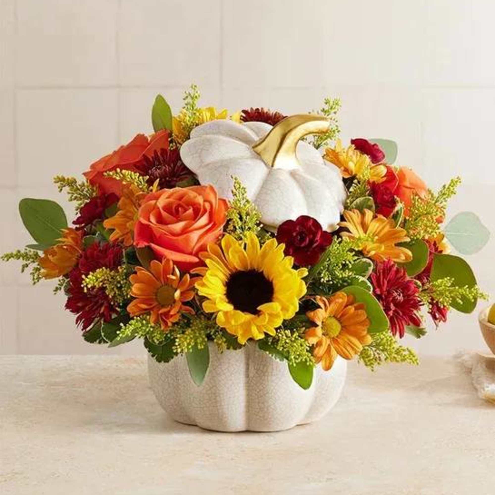 A plentiful mix of blooms gives our autumn arrangement an undeniable charm.