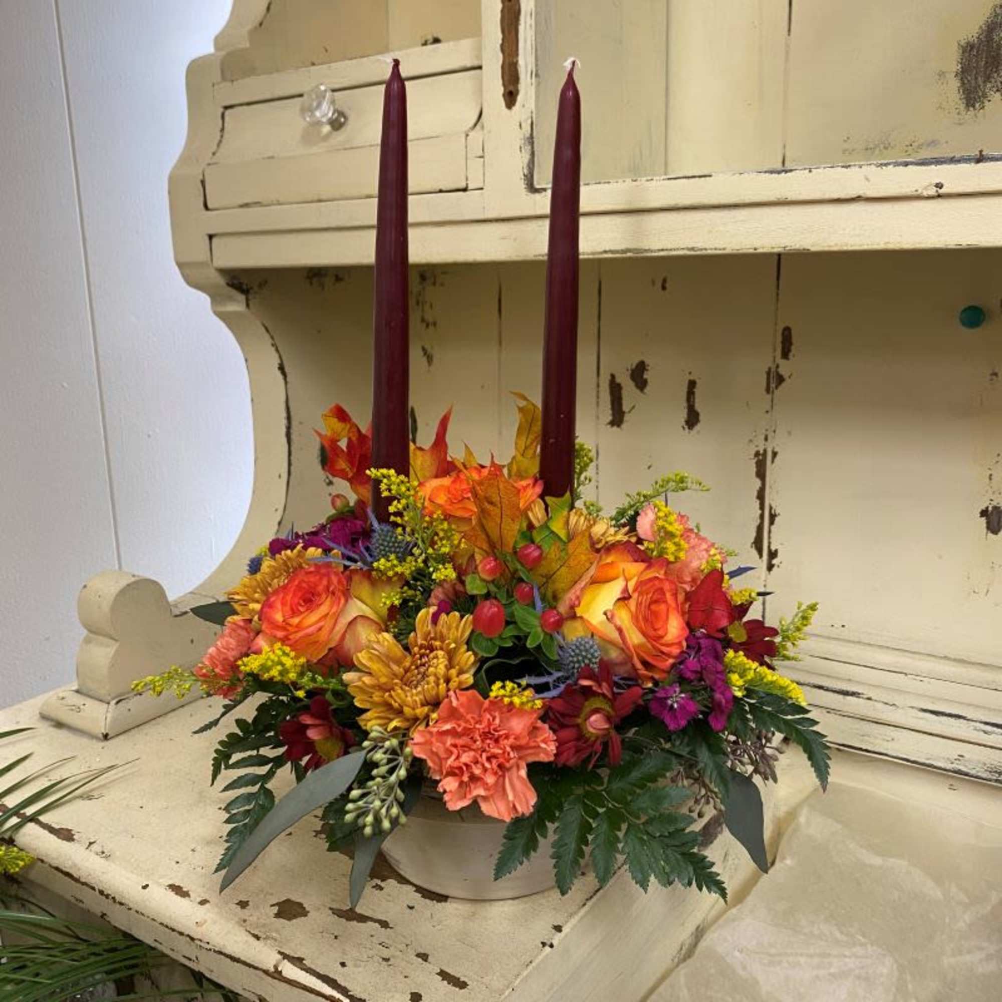 This sweet arrangement with a holiday candle will bring your family table