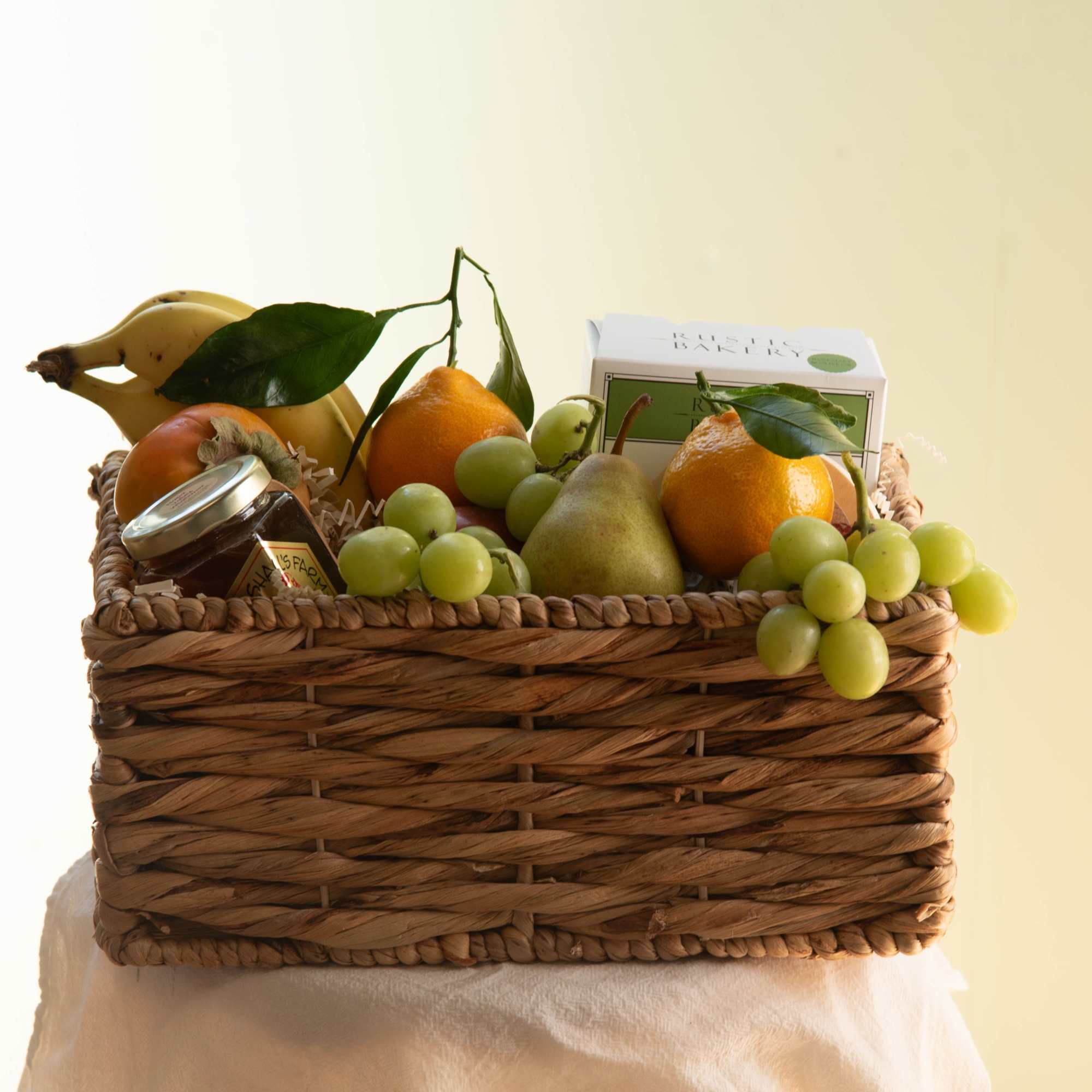 Our fruit basket is elevated with Rustic Bakery Crackers, local Napa honey