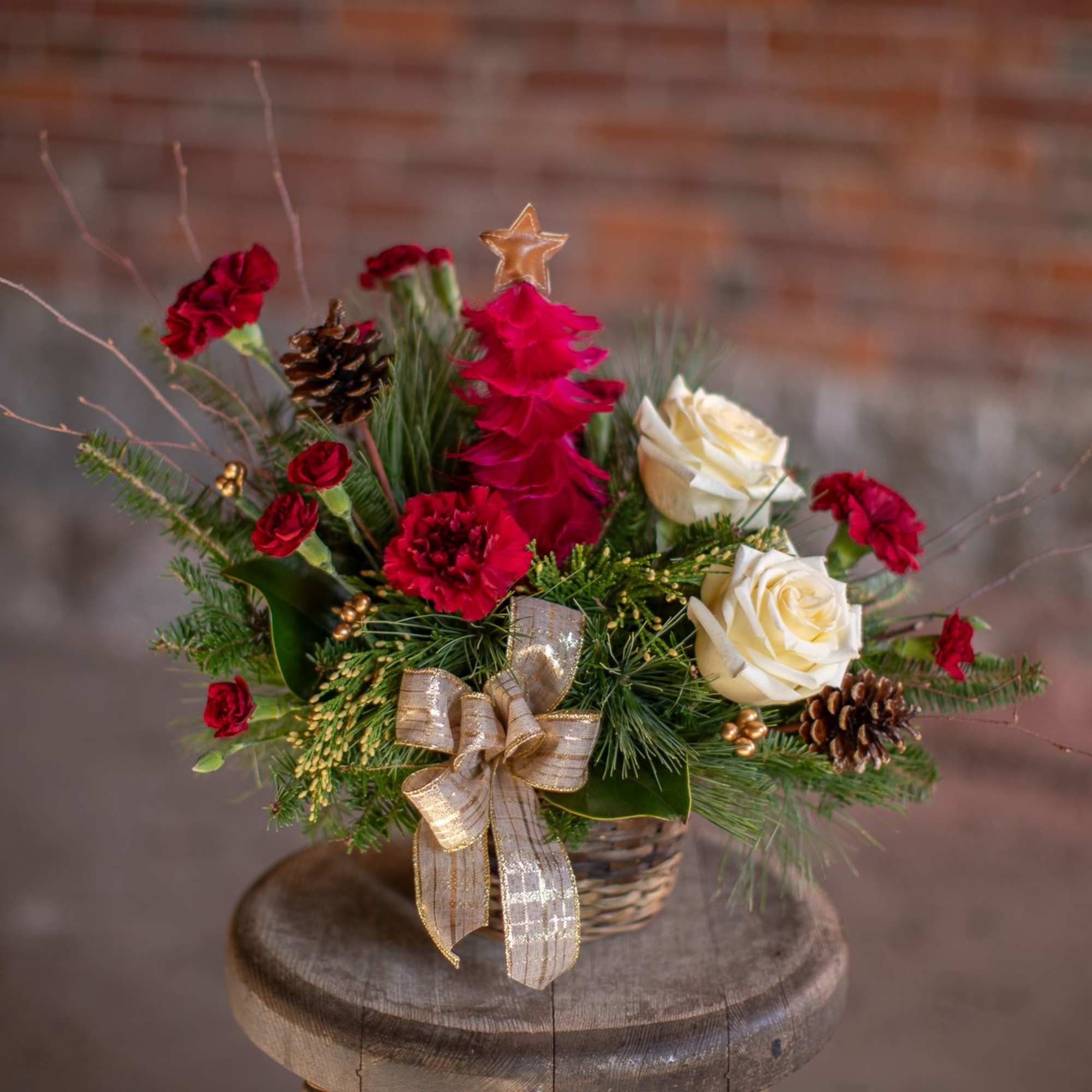 A decorative and festive tree made from crimson feather with a gold