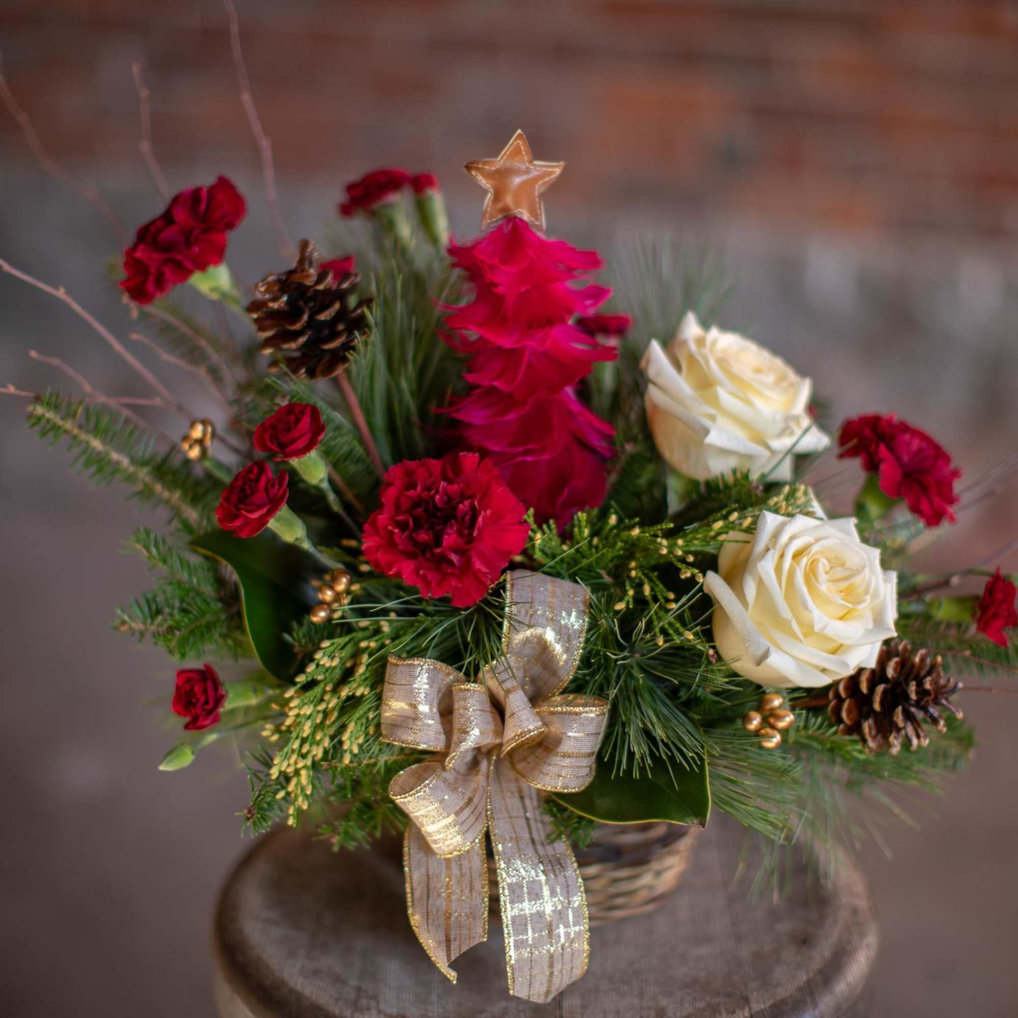 A decorative and festive tree made from crimson feather with a gold