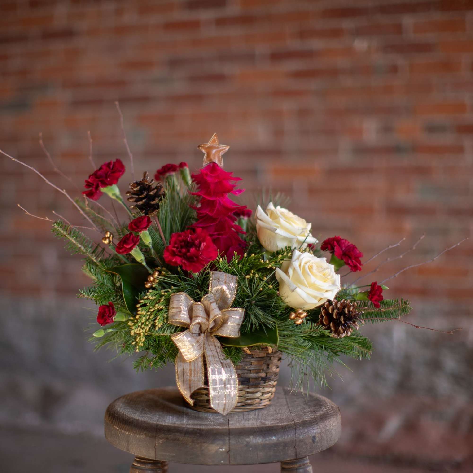 A decorative and festive tree made from crimson feather with a gold