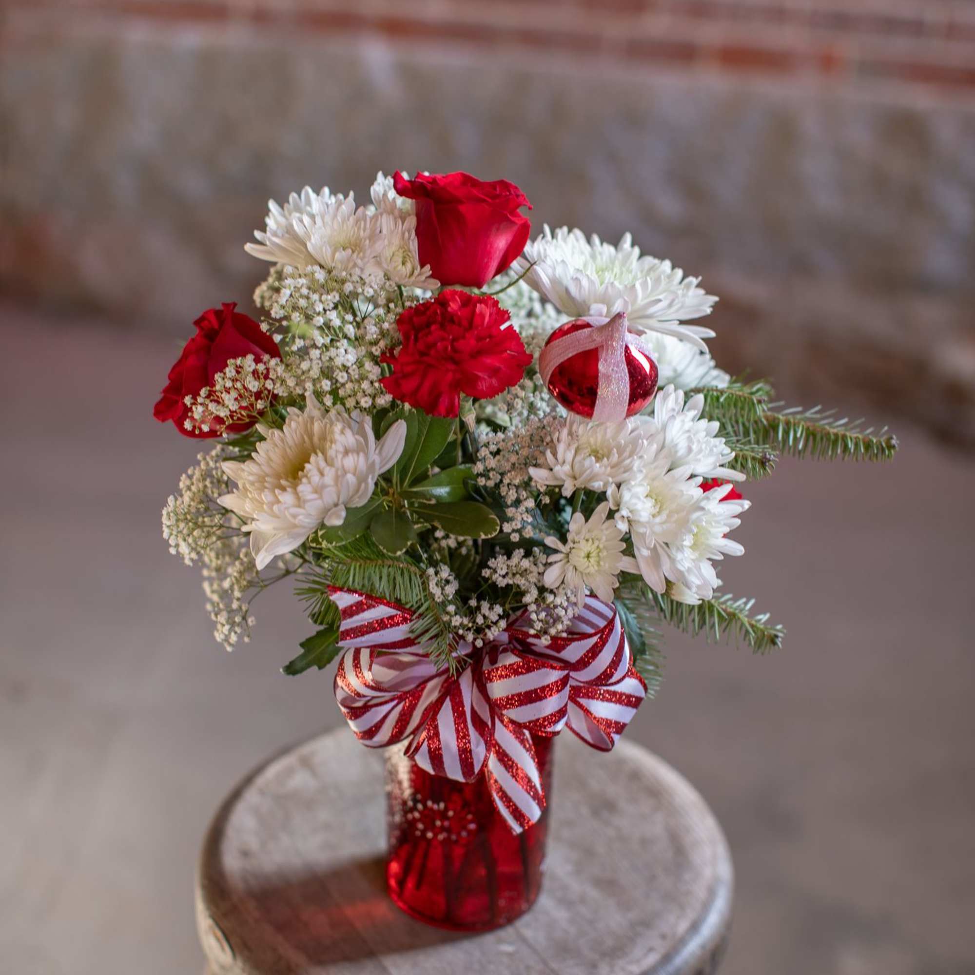 A ruby red textured jar vase holds crisp, sweet and spicy blooms.