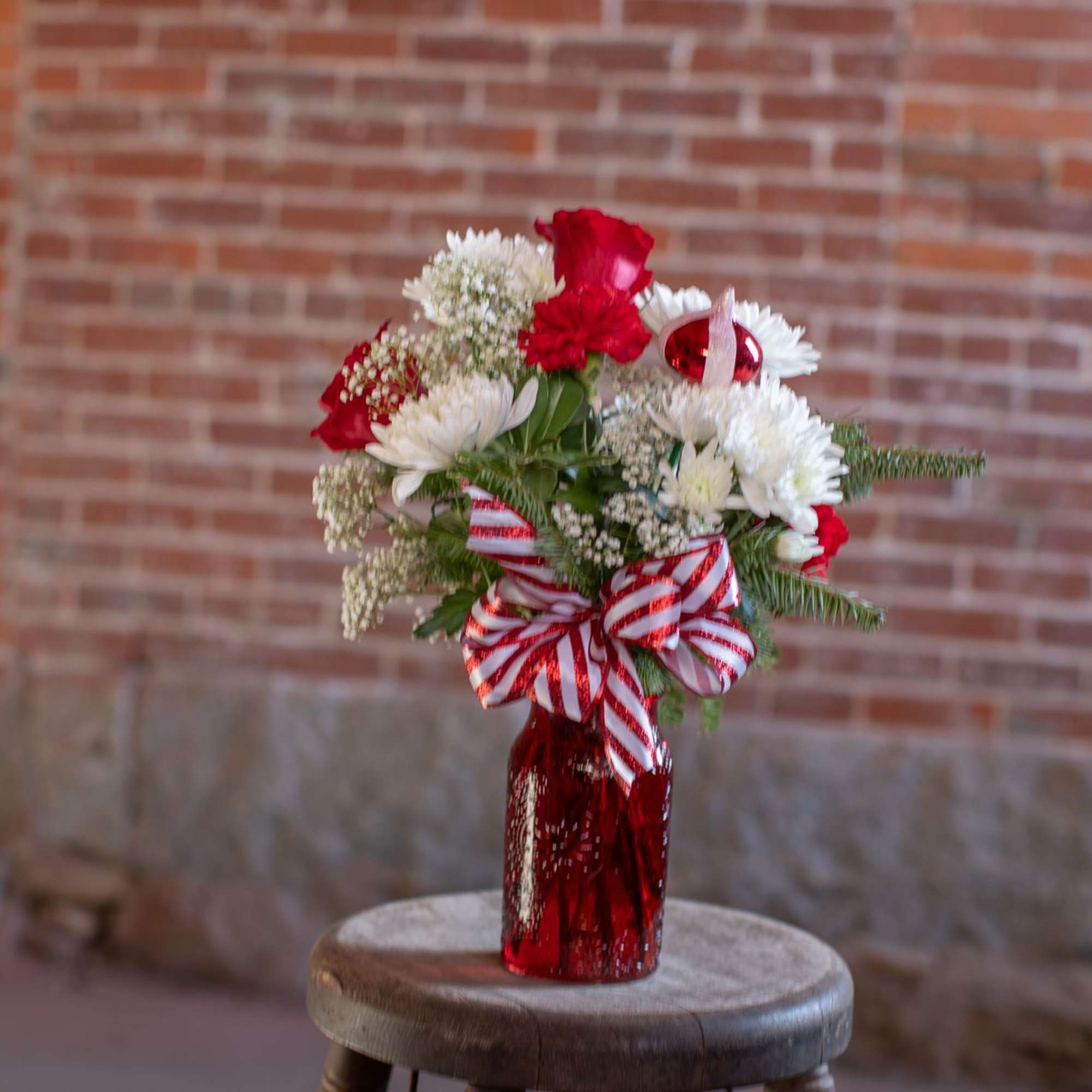 A ruby red textured jar vase holds crisp, sweet and spicy blooms.