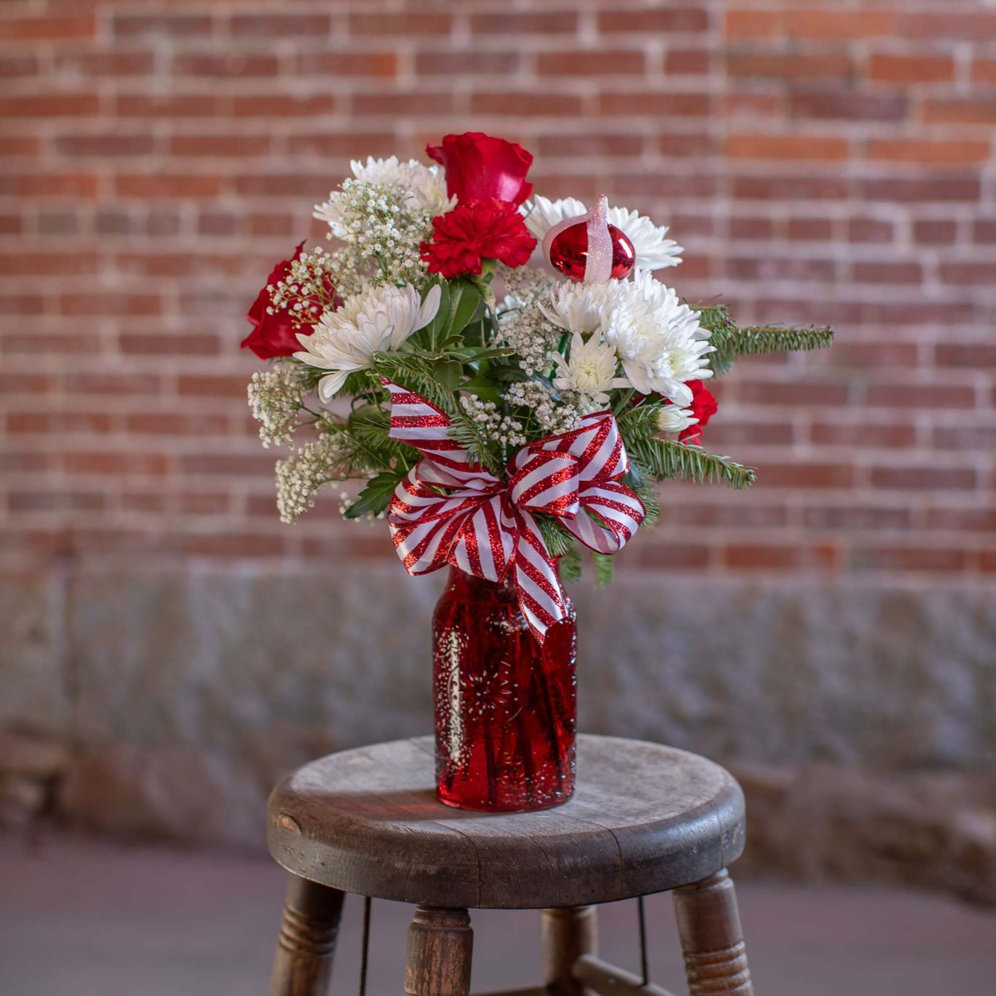 A ruby red textured jar vase holds crisp, sweet and spicy blooms.