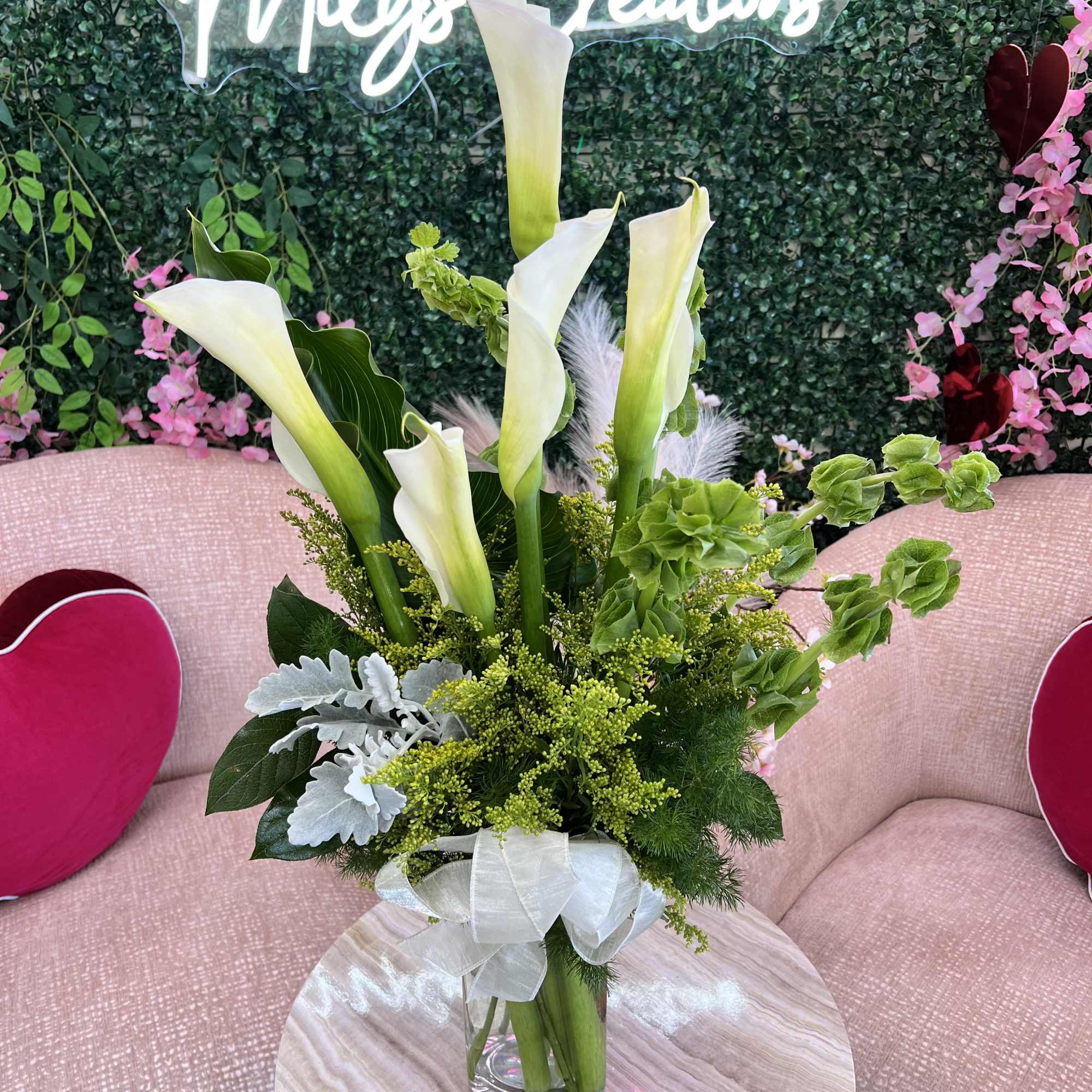 A stunning arrangement of fresh Calla Lilies, known for their sleek, trumpet-like