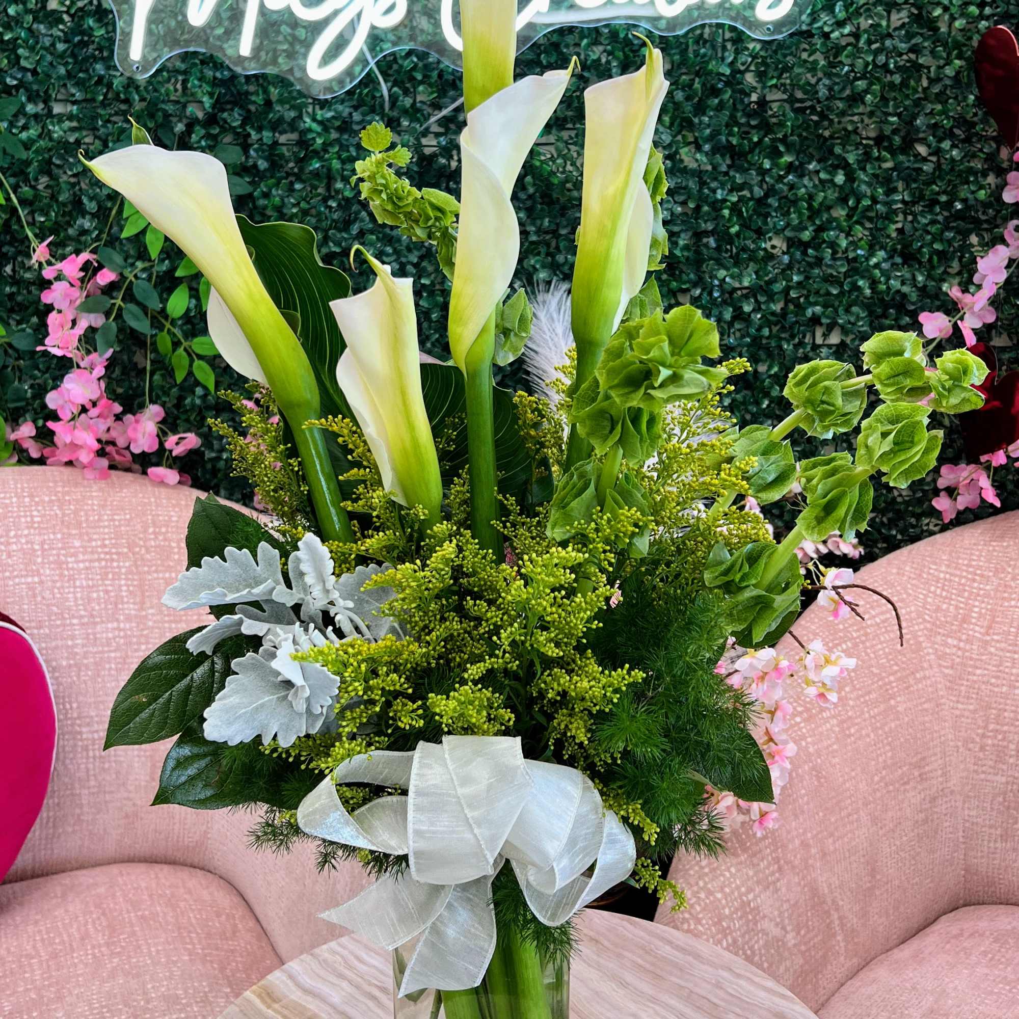 A stunning arrangement of fresh Calla Lilies, known for their sleek, trumpet-like