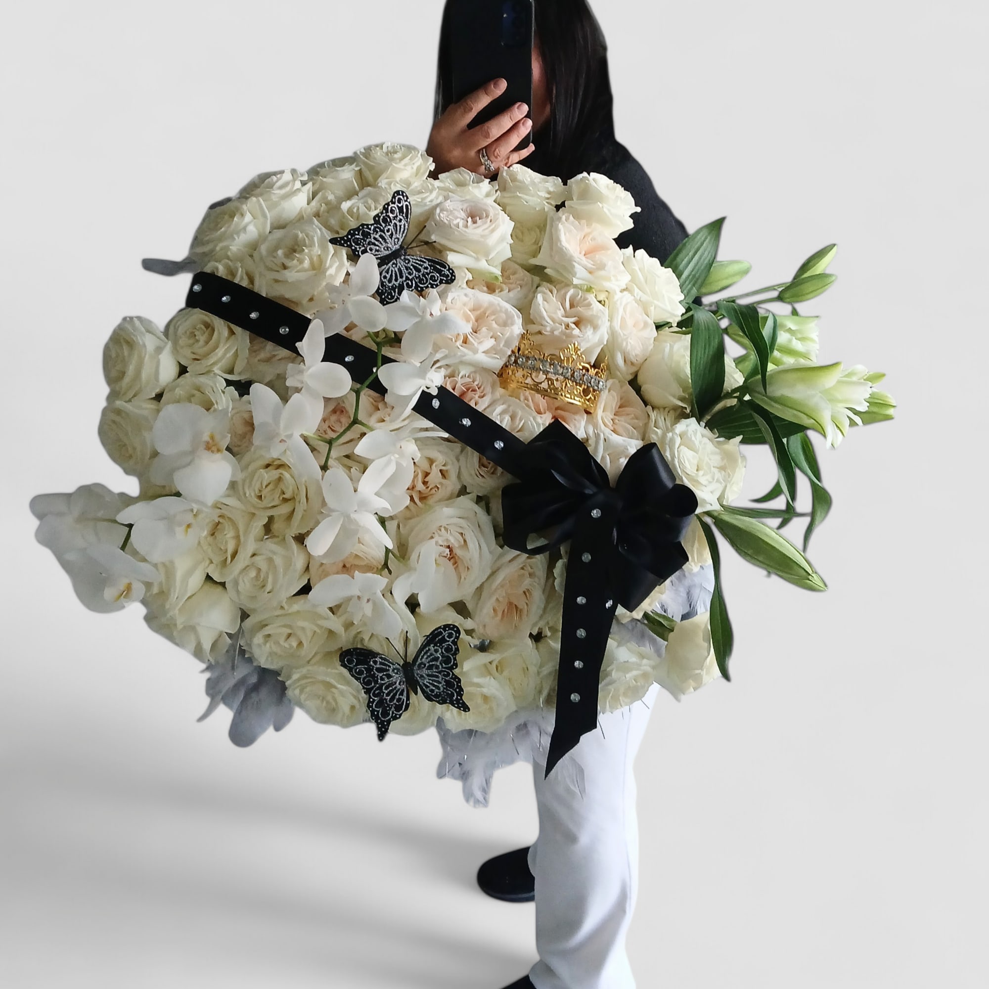 Grande 5 dozen white roses with orchids and lilies arranged with black