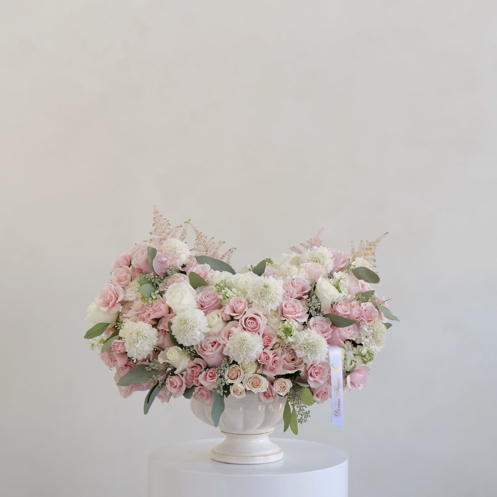 A lush and romantic arrangement featuring a mix of soft pink and