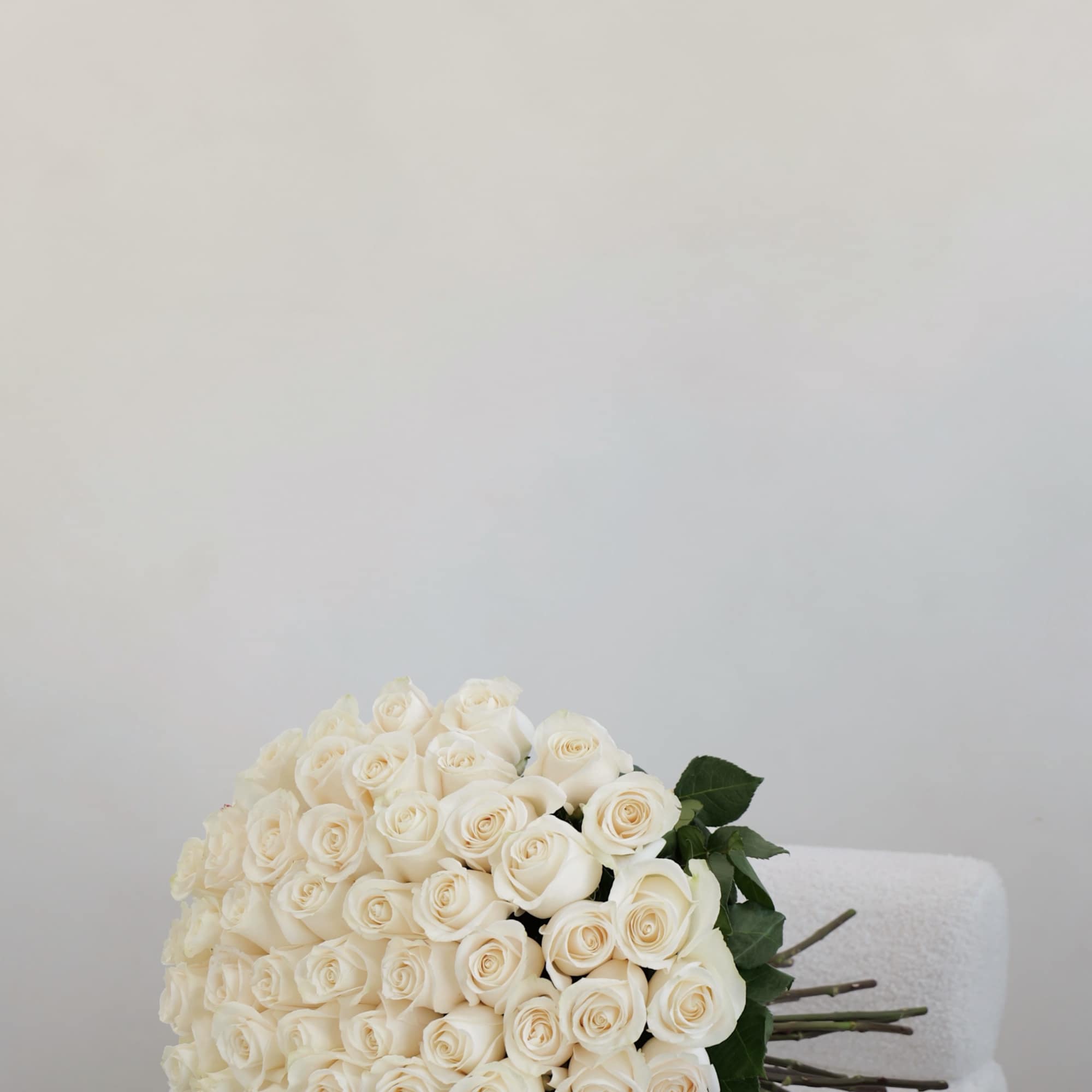 A timeless and classic bouquet of white roses, beautifully arranged to create