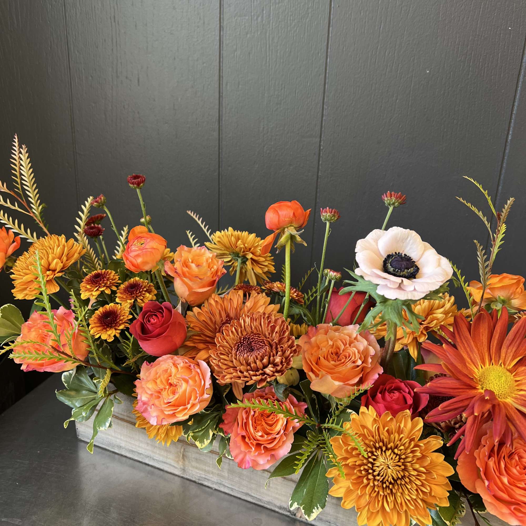 Arranged in a 20&rdquo; long rectangular wooden planter. This arrangement is a