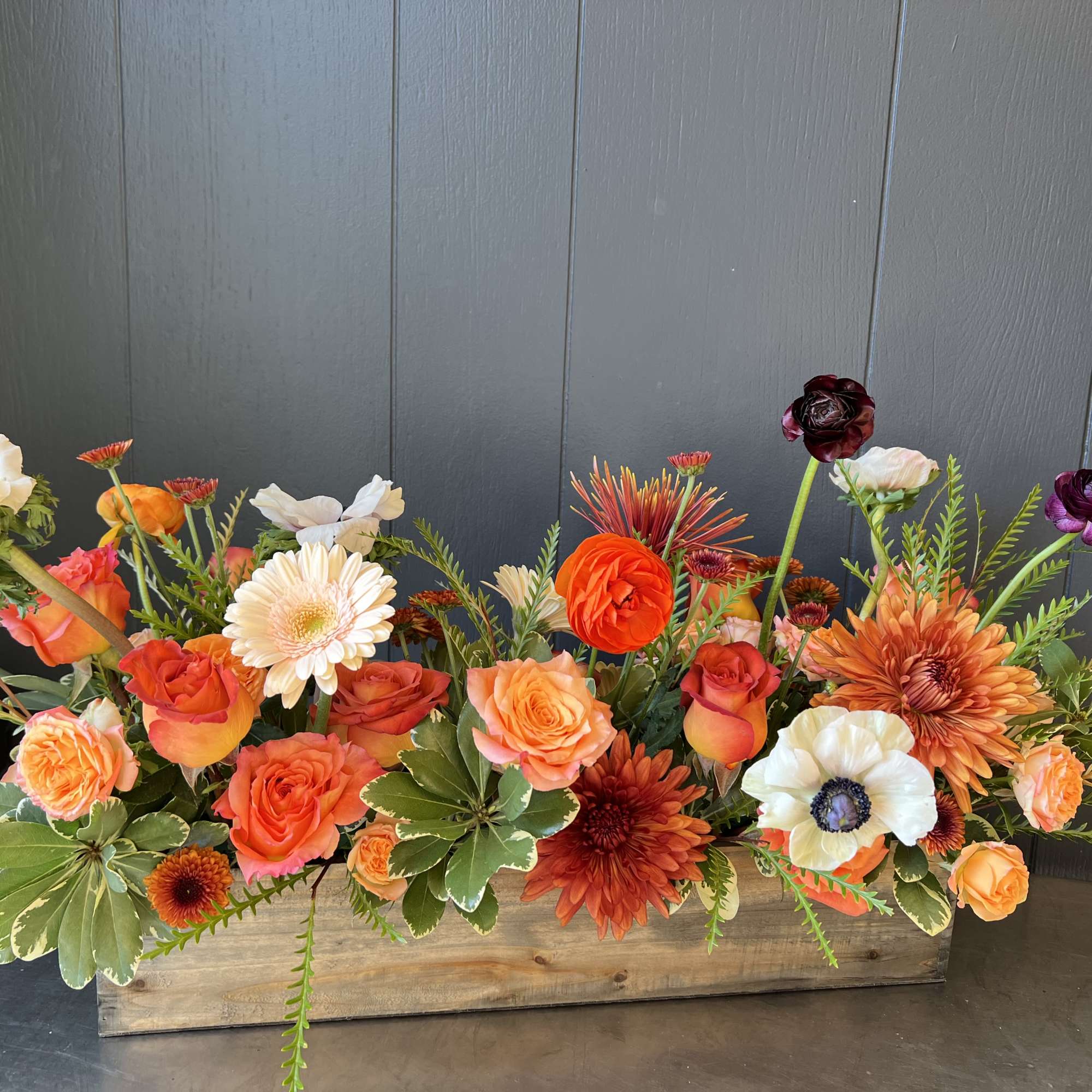Arranged in a 20&rdquo; long rectangular wooden planter. This arrangement is a