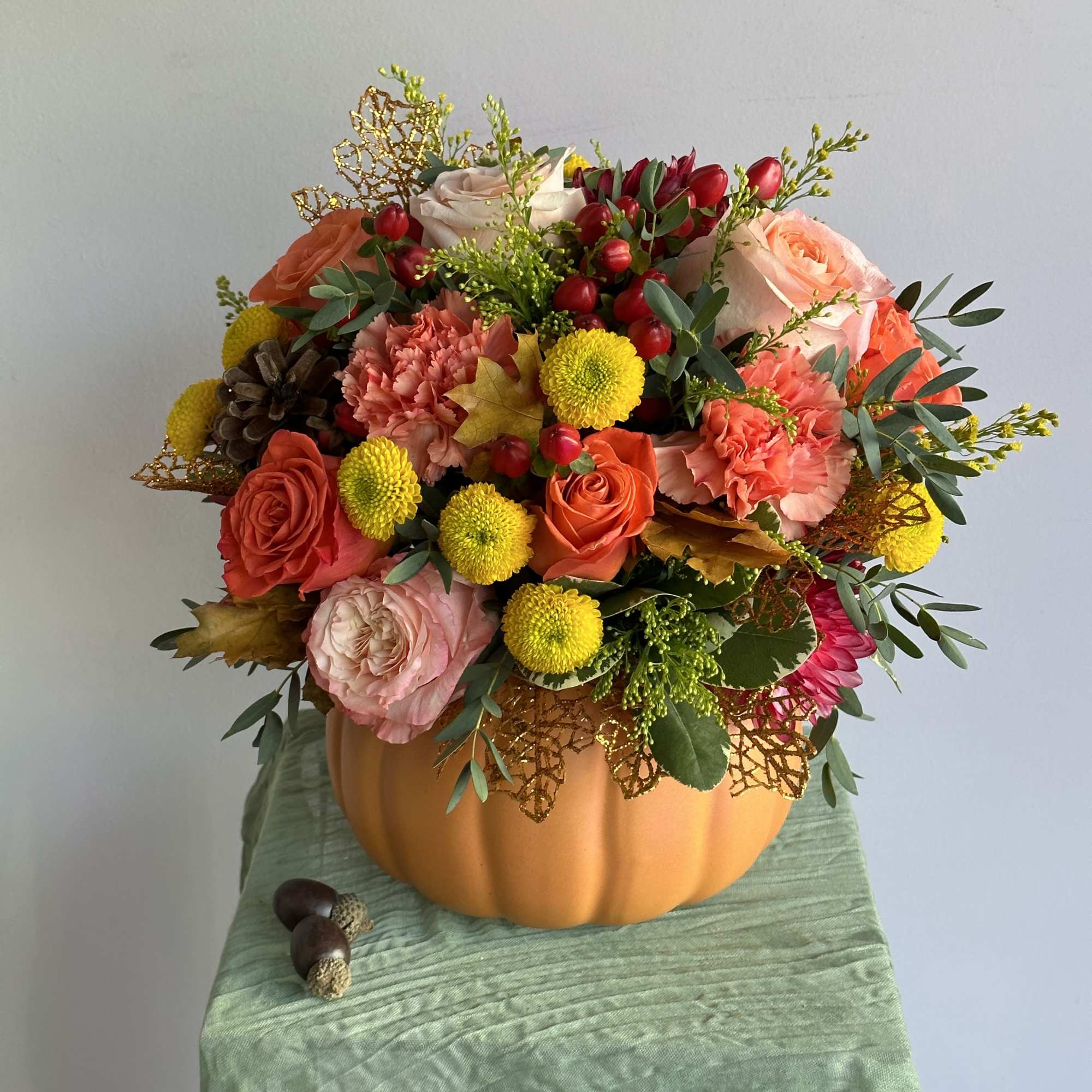 Thanksgiving flower arrangements in ceramic pumpkins are a festive and stylish gift