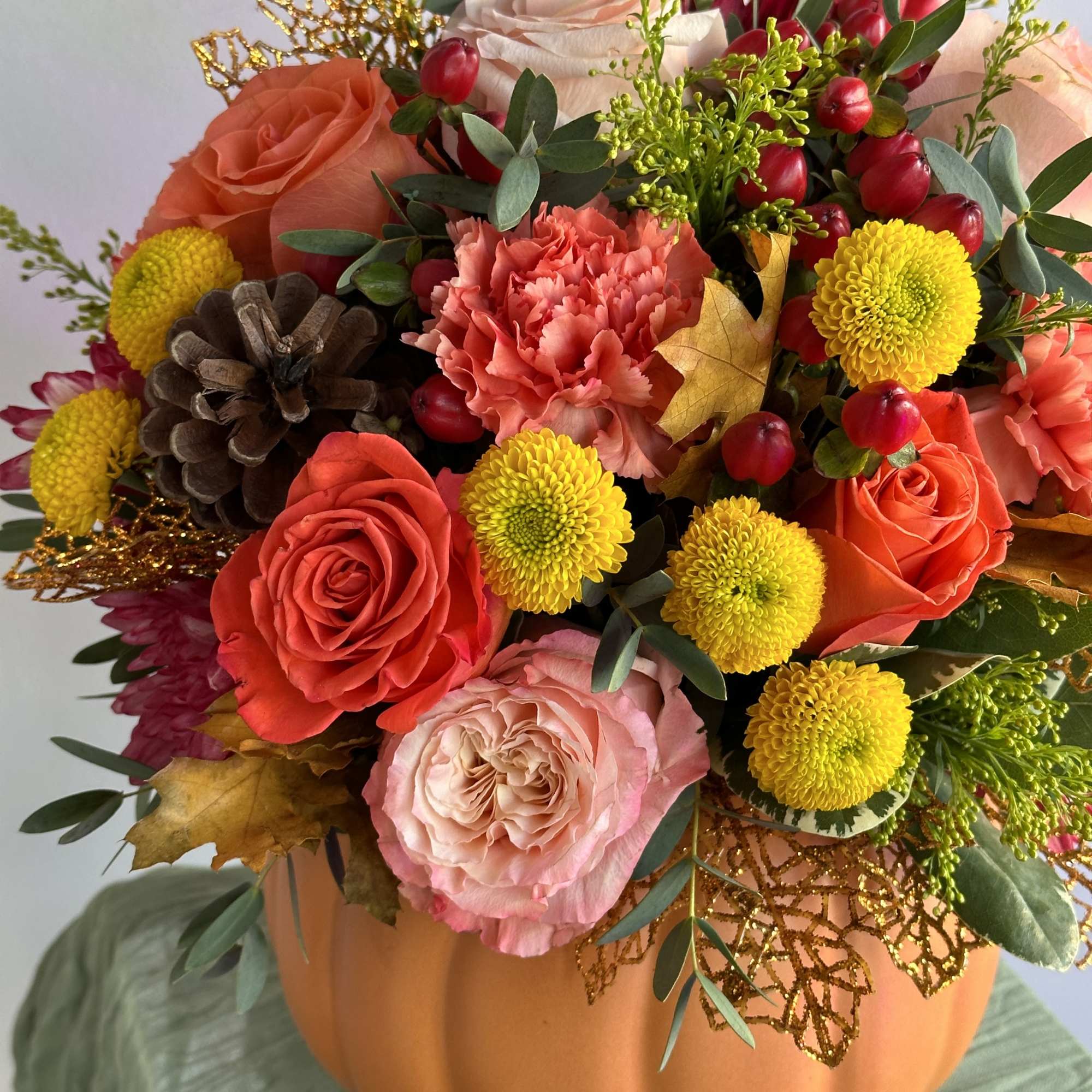 Thanksgiving flower arrangements in ceramic pumpkins are a festive and stylish gift