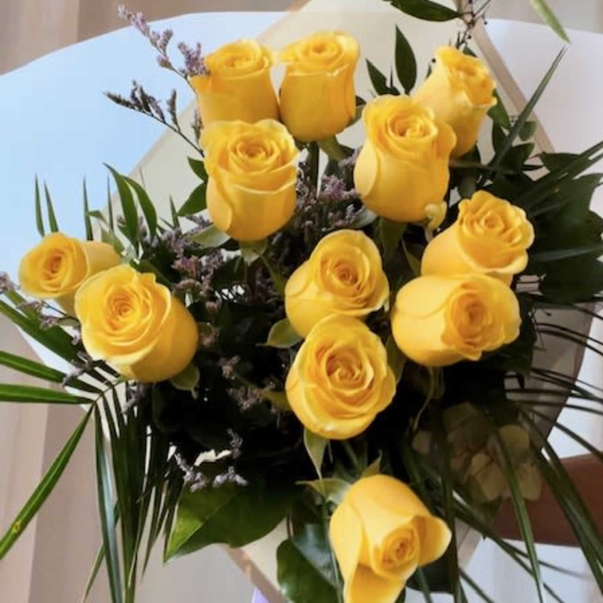 Featuring luxurious roses arranged in lush greenery, wrapped in premium paper and