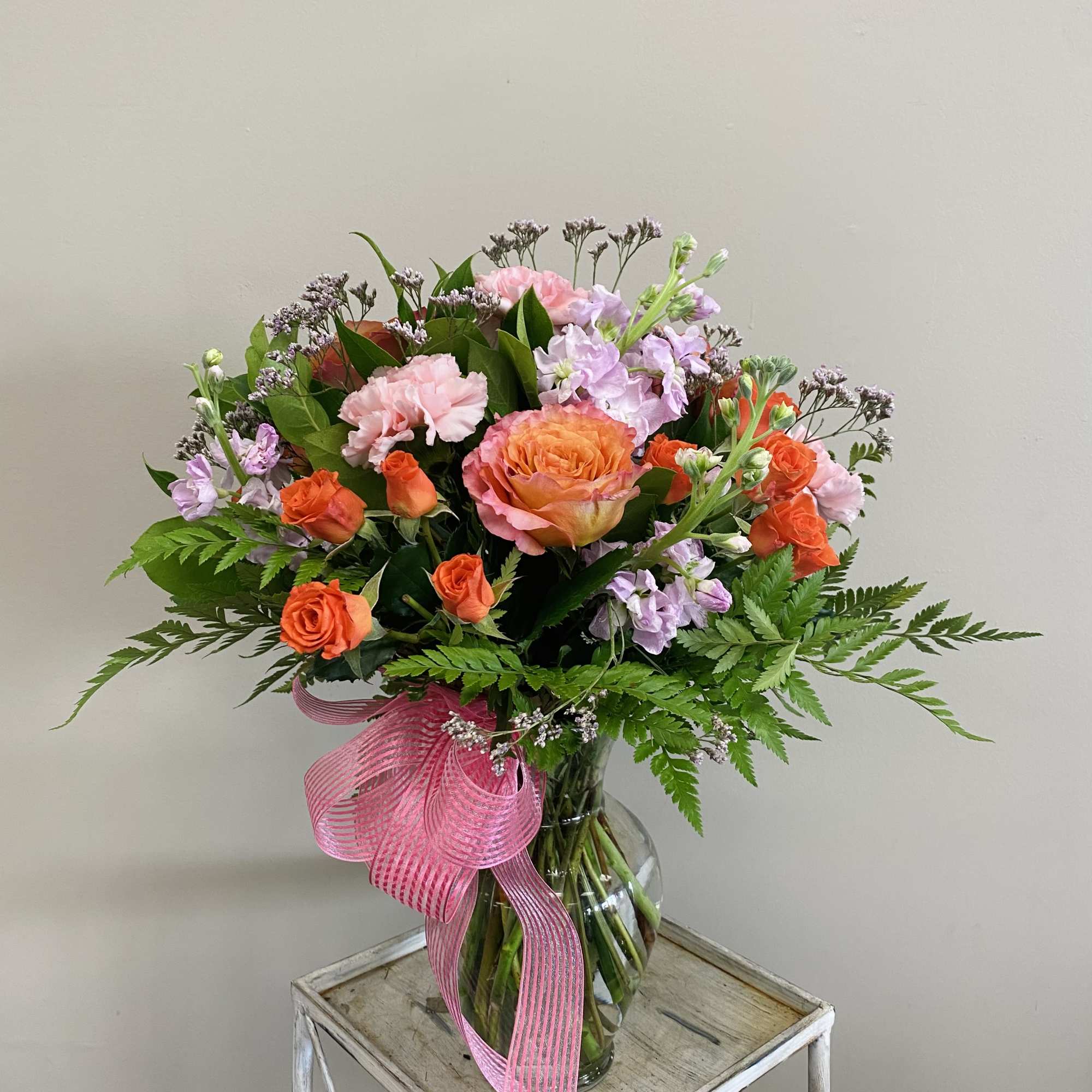 Celebrate good times with this lively bouquet. The arrangement includes roses, carnations