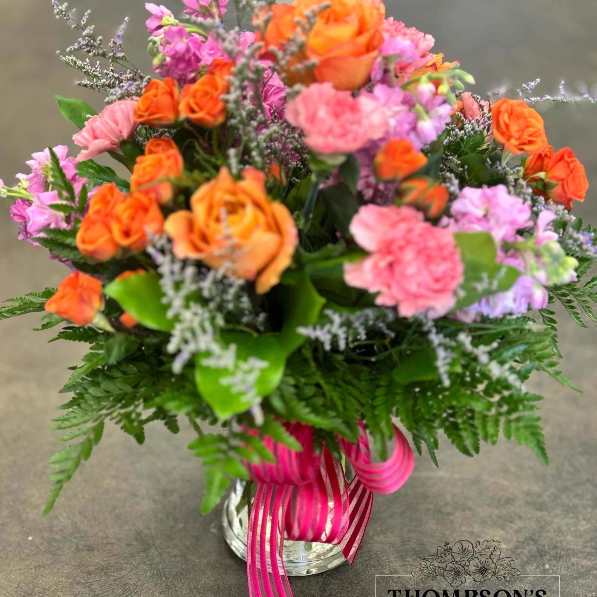 Celebrate good times with this lively bouquet. The arrangement includes roses, carnations