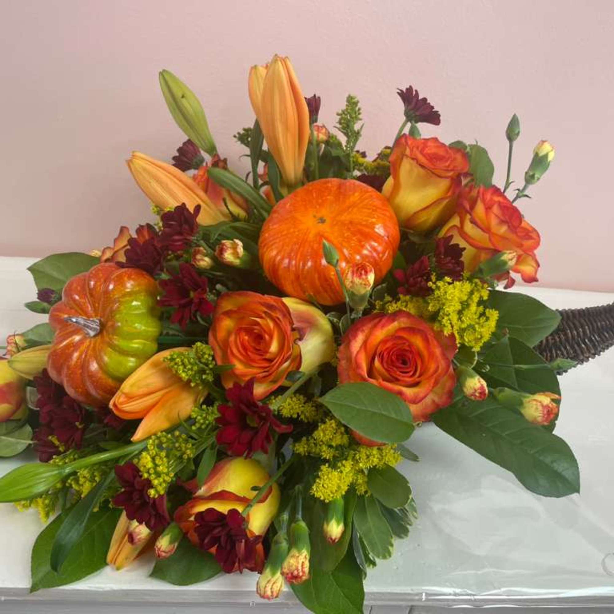 Thanksgiving centerpiece made in a horn with roses, lilies, sunflowers and daisies