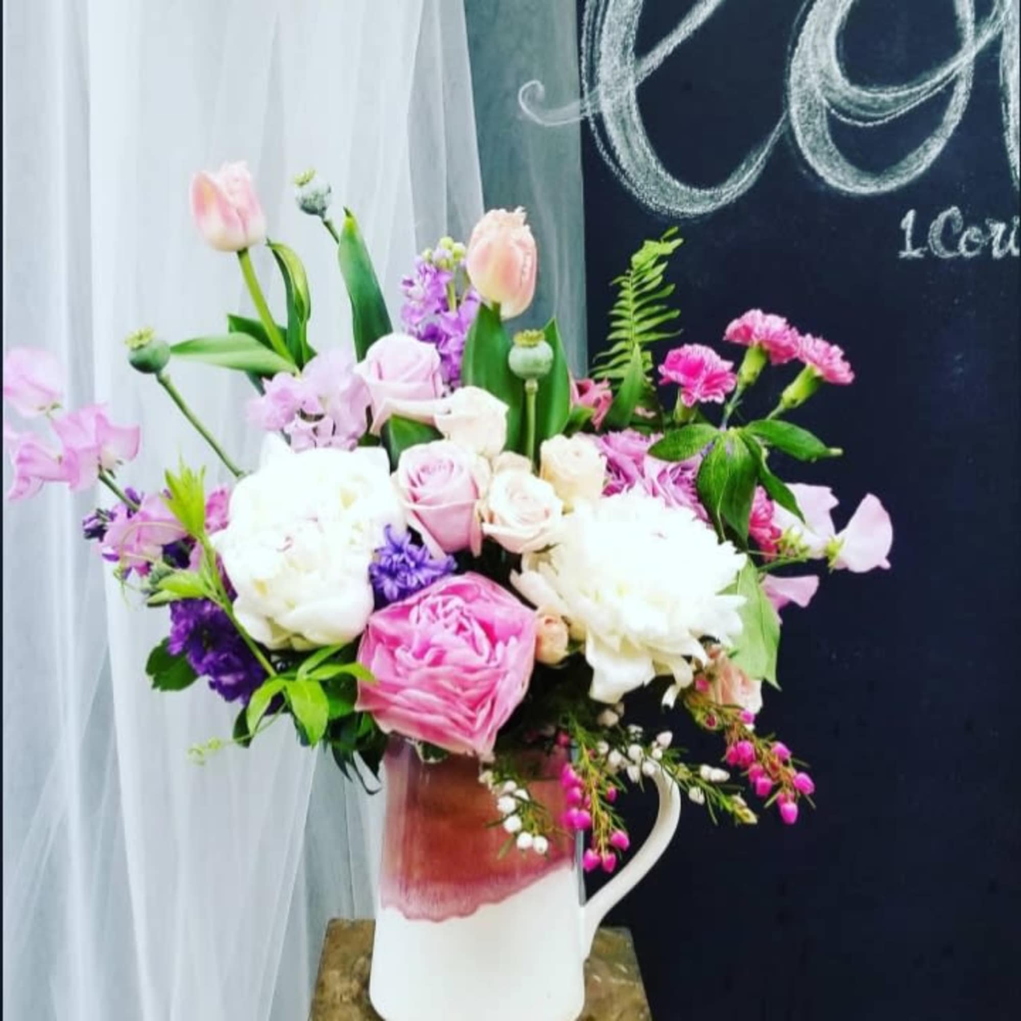 Mixture of colorful flowers in ceramic containers.*Reasonable flower substitutions may be made