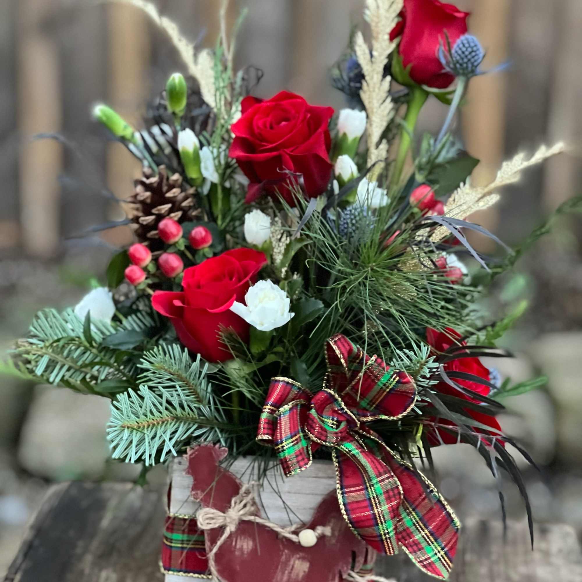 A beautiful flower arrangement nestled in a wooden box and includes a