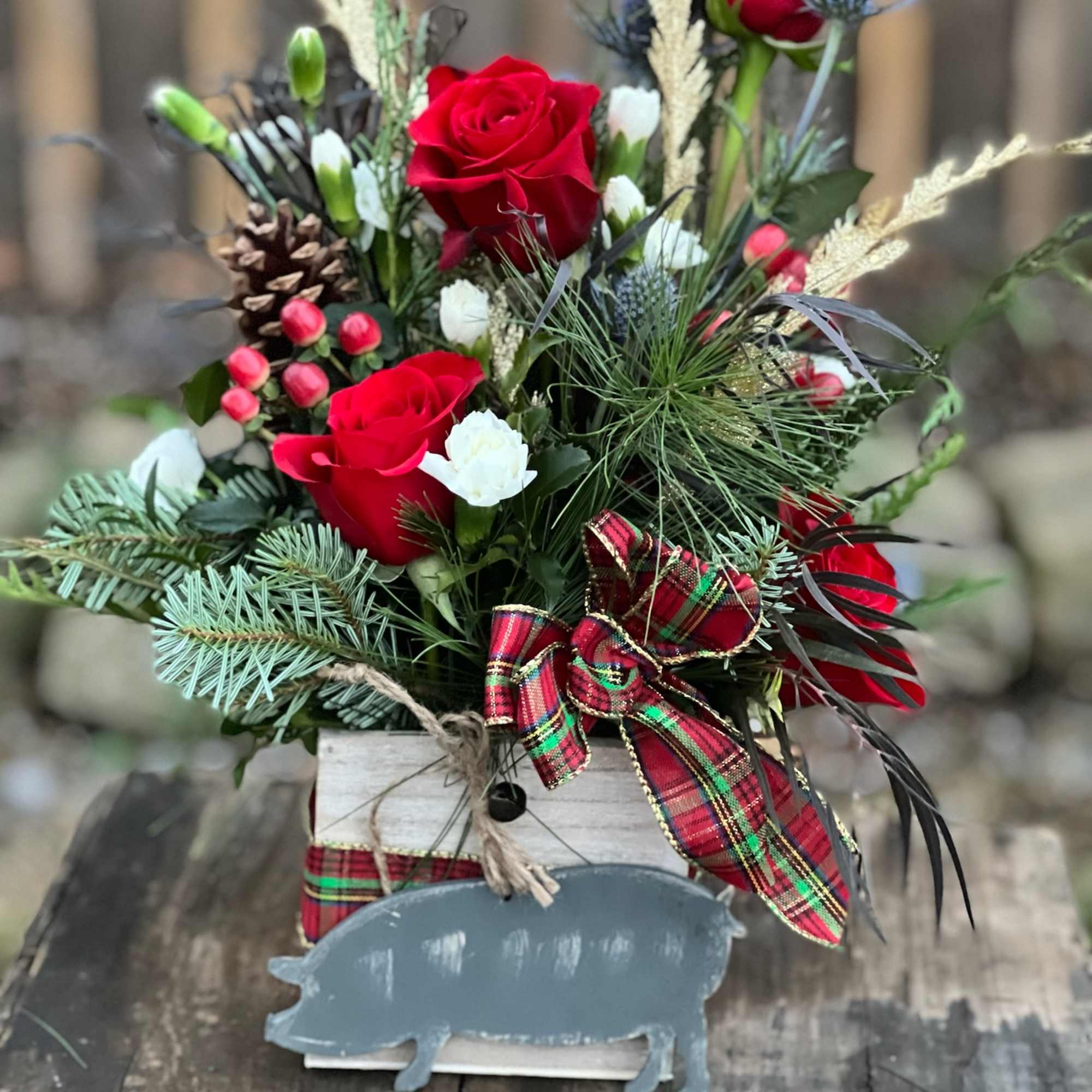 A beautiful flower arrangement nestled in a wooden box and includes a