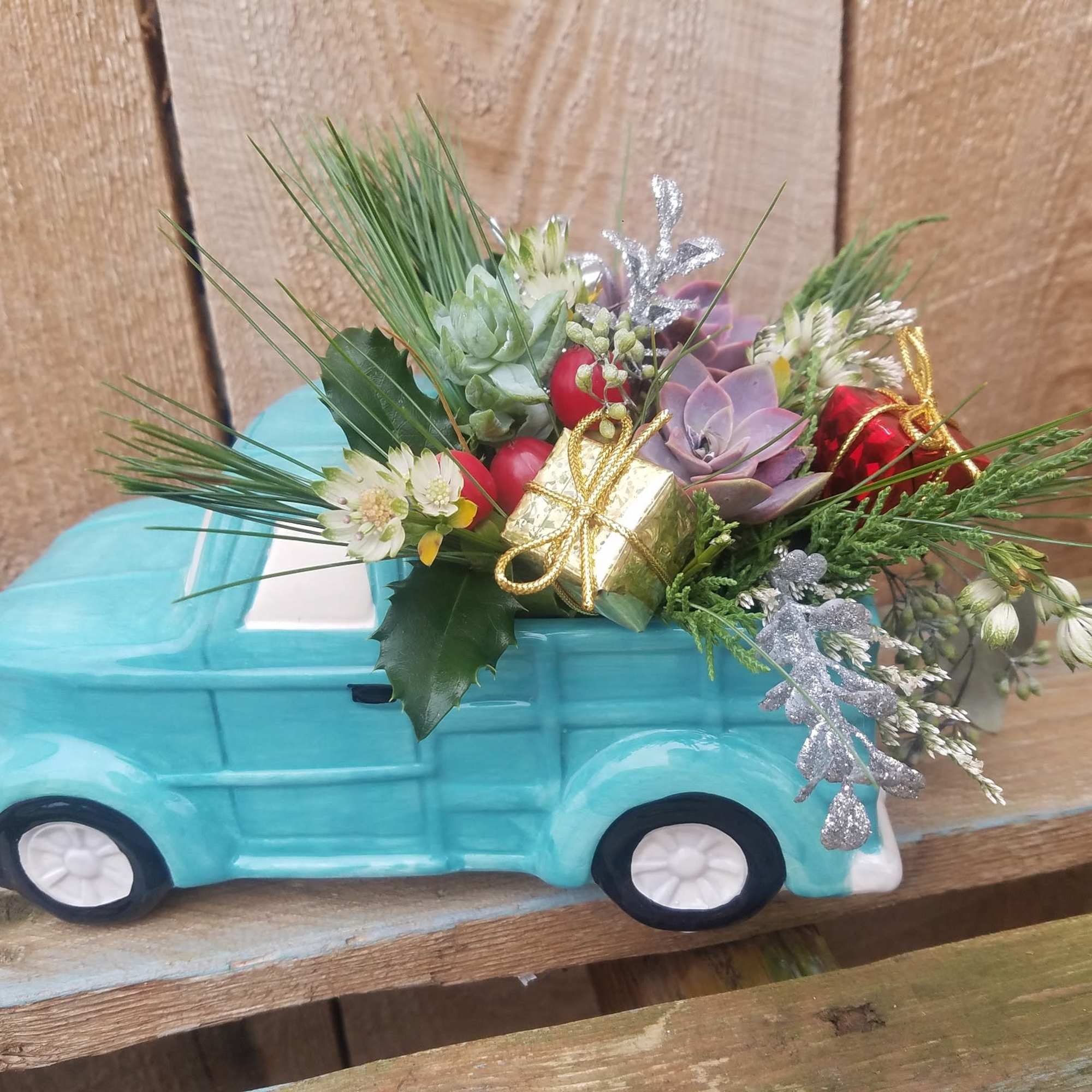 This charming old fashioned truck has a bed filled with fresh pine