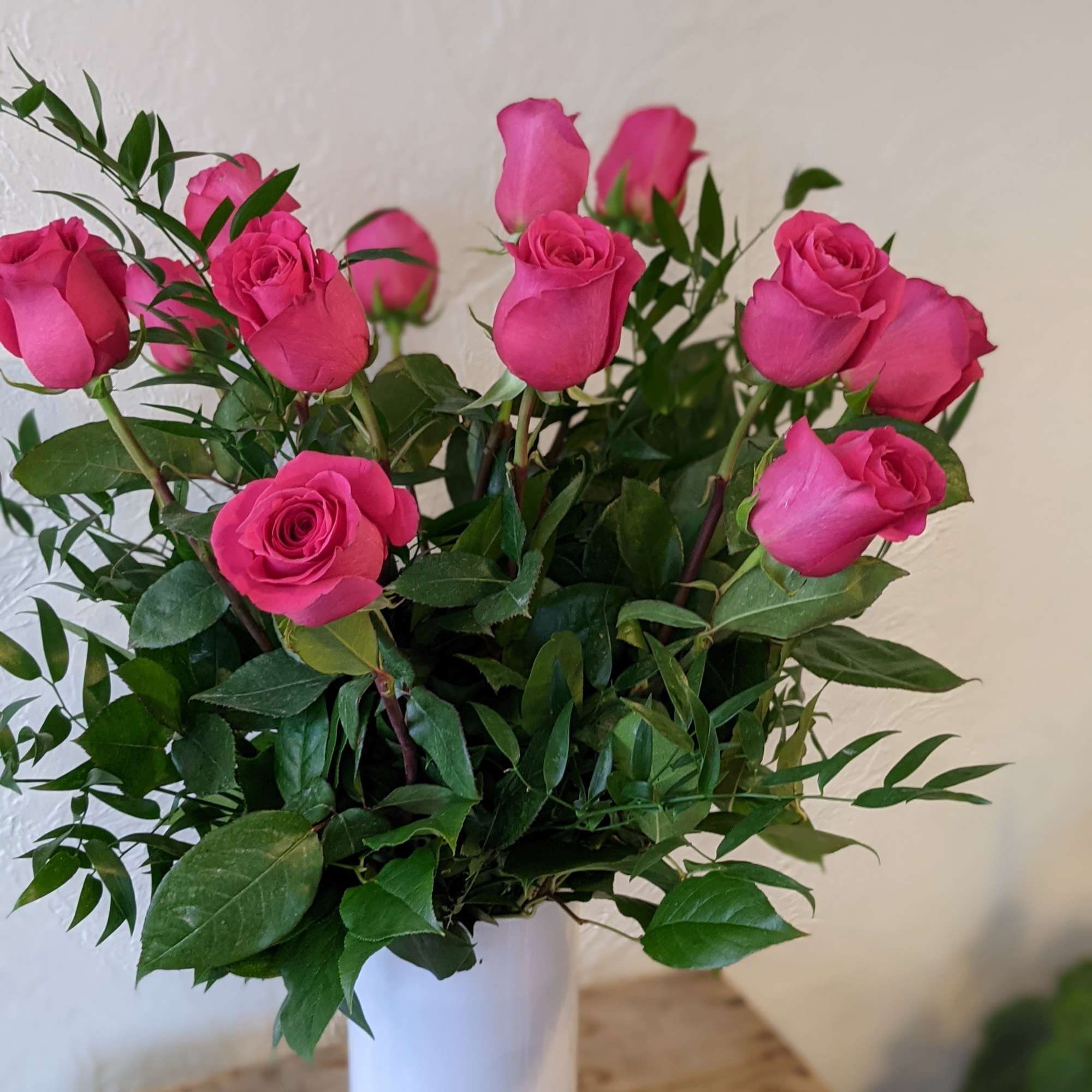A timeless classic, send a dozen roses in a vase with complementing