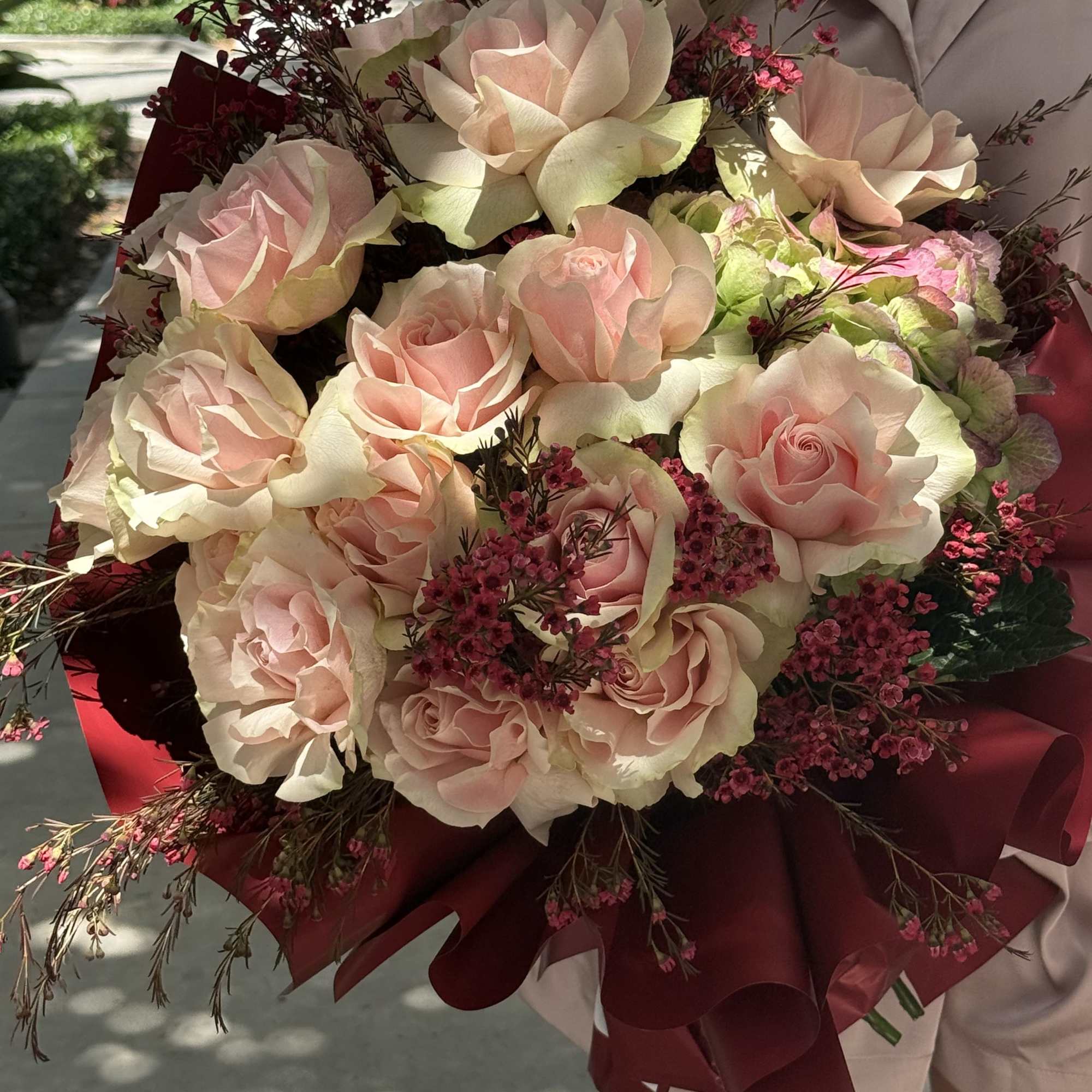 Burgundy Charm is a romantic bouquet featuring soft blush roses paired with