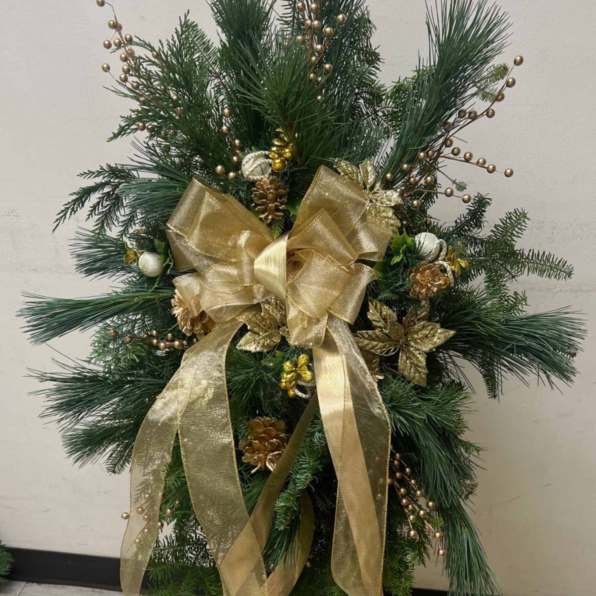 GOLD EVERGREEN SWAG ON EASEL BY TWIN TOWERS FLORIST 