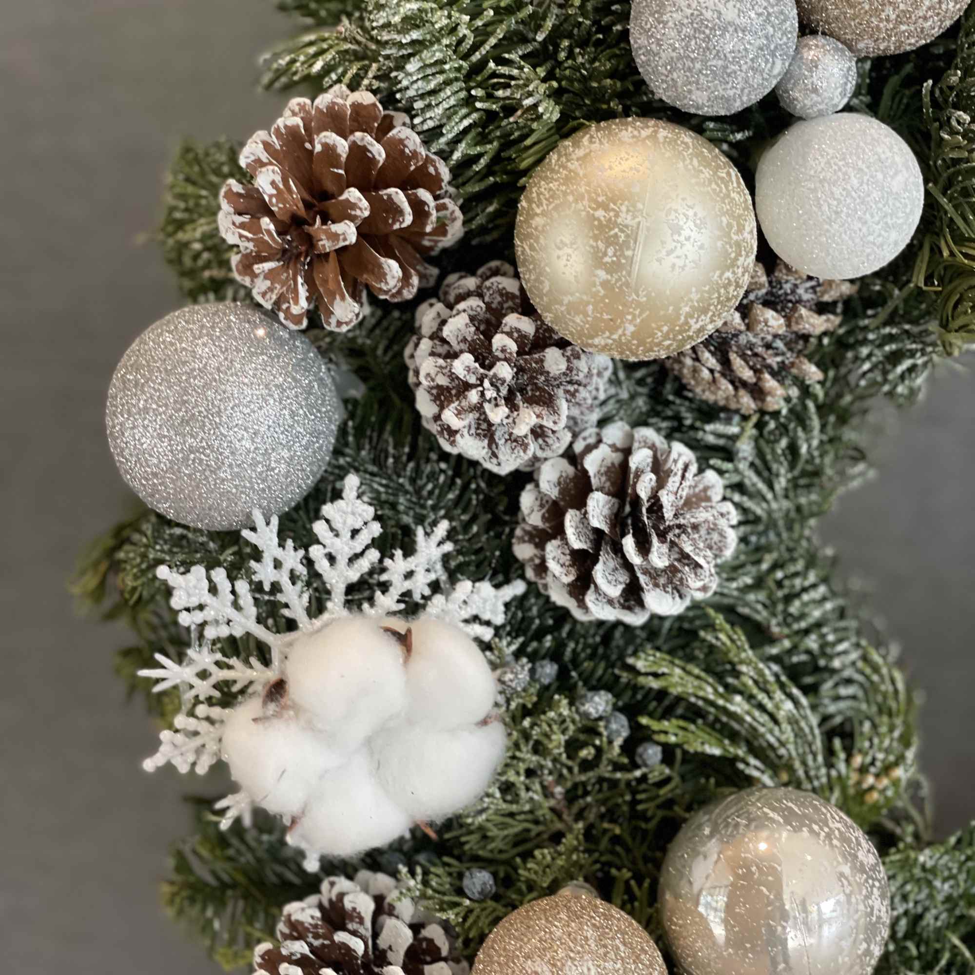 This luxurious winter wreath is crafted from fresh evergreens and adorned with