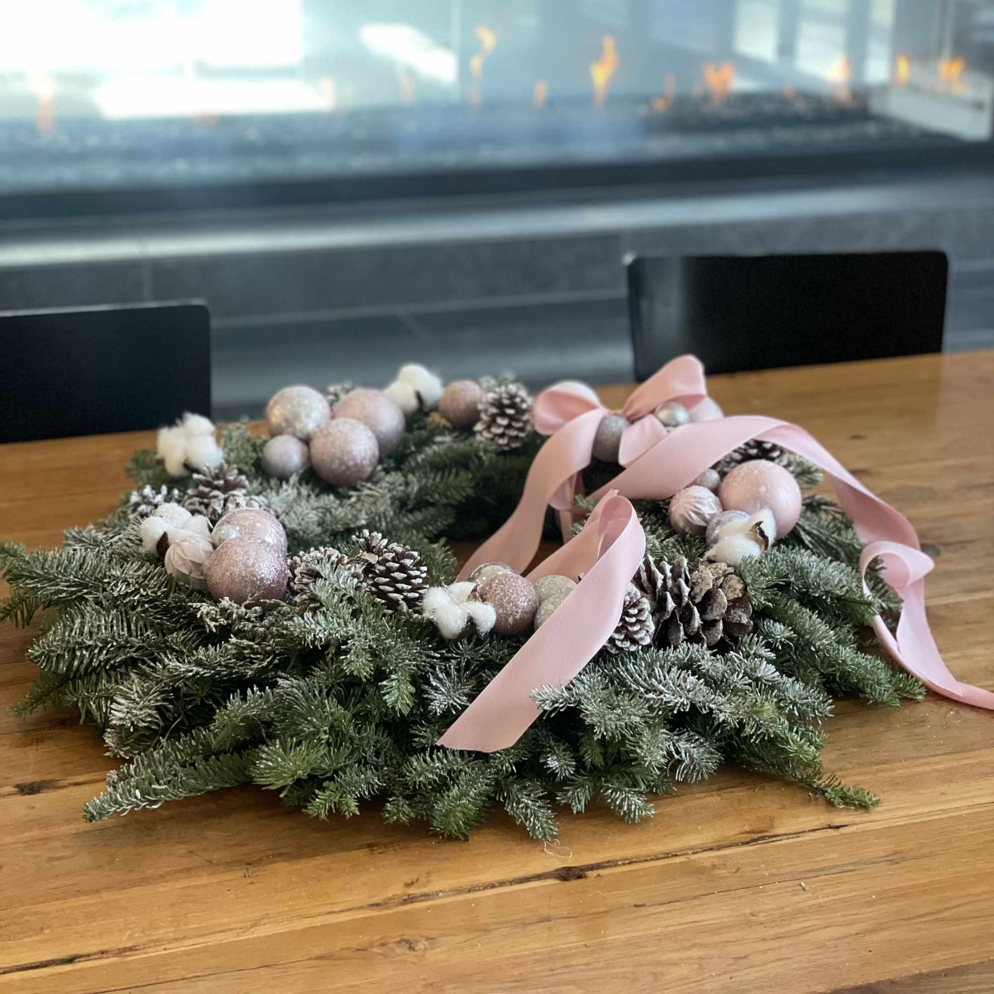 This soft and elegant holiday wreath features fresh snowy evergreens adorned with