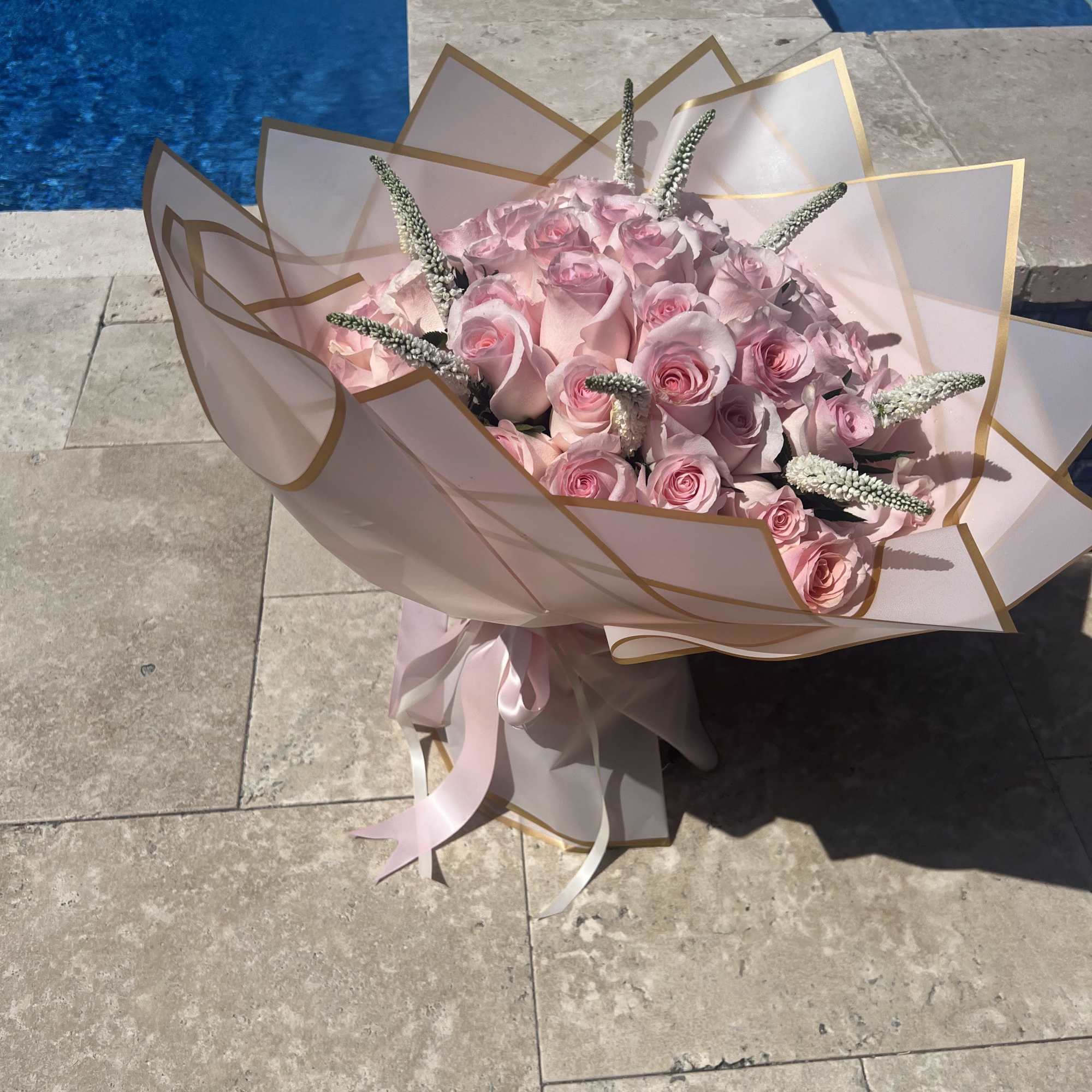 This elegant bouquet features fresh roses complemented by delicate veronica flowers, creating