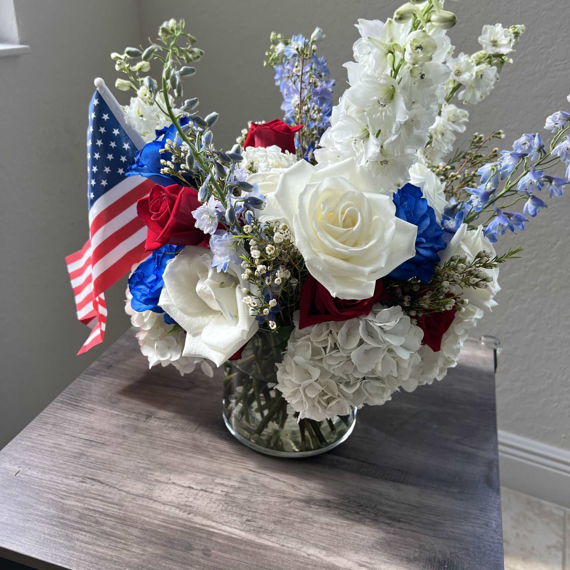Celebrate American pride with this vibrant red, white, and blue centerpiece arranged