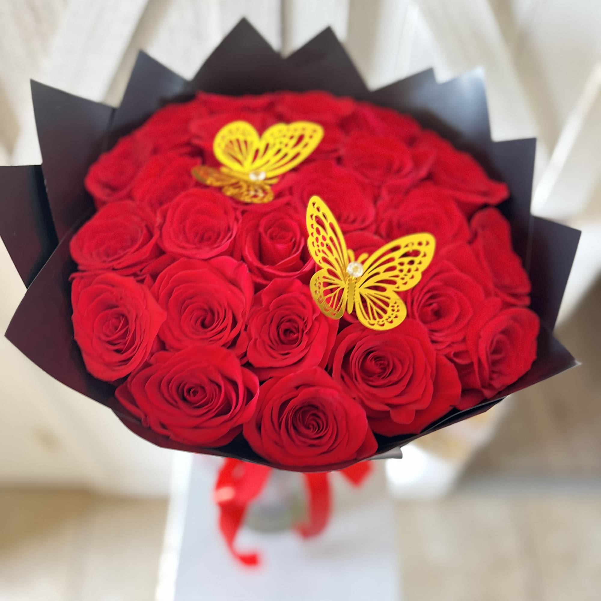 A stunning display of  2 Dozen passionate red roses, each symbolizing