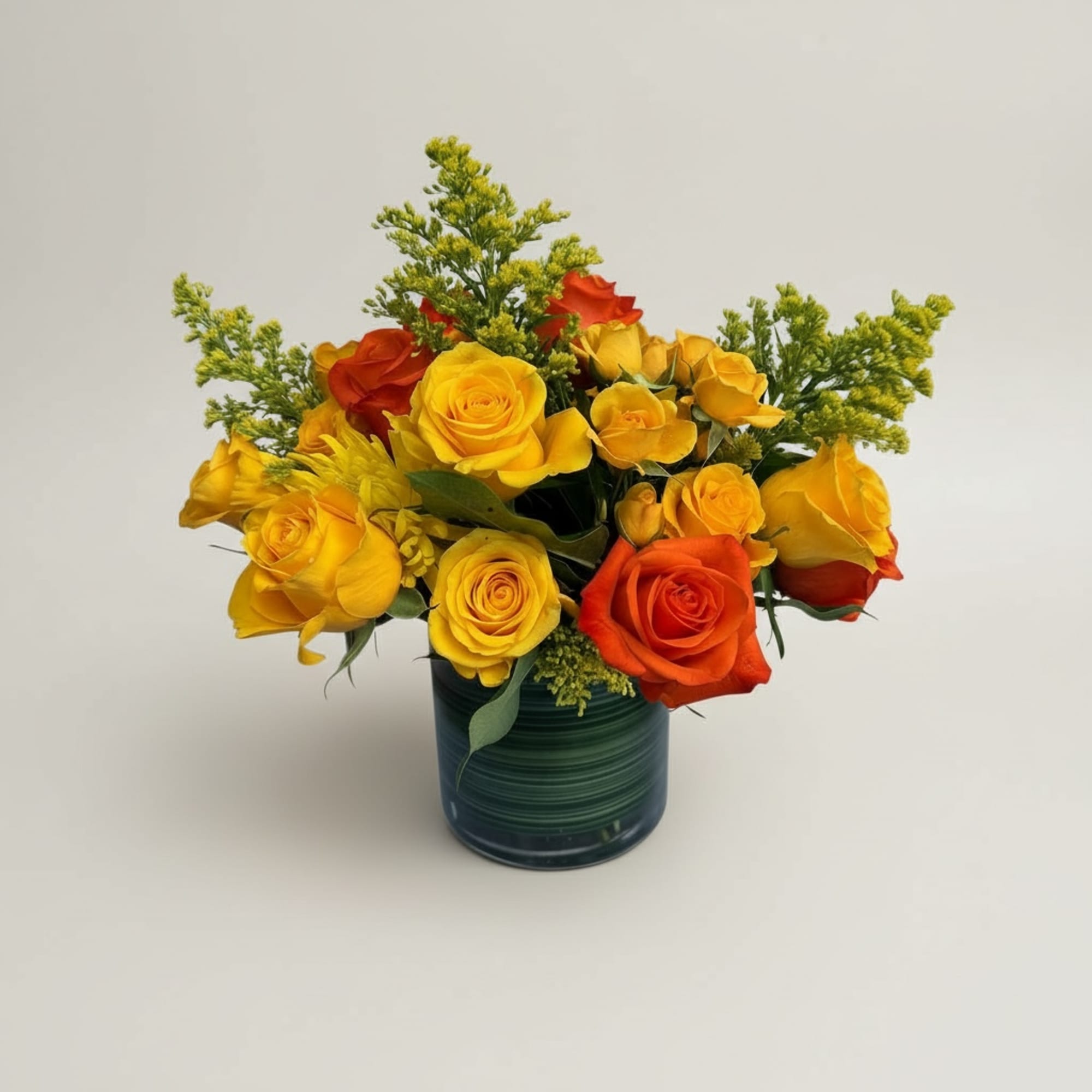 Yellow and orange roses come together for a fun and fresh arrangement.