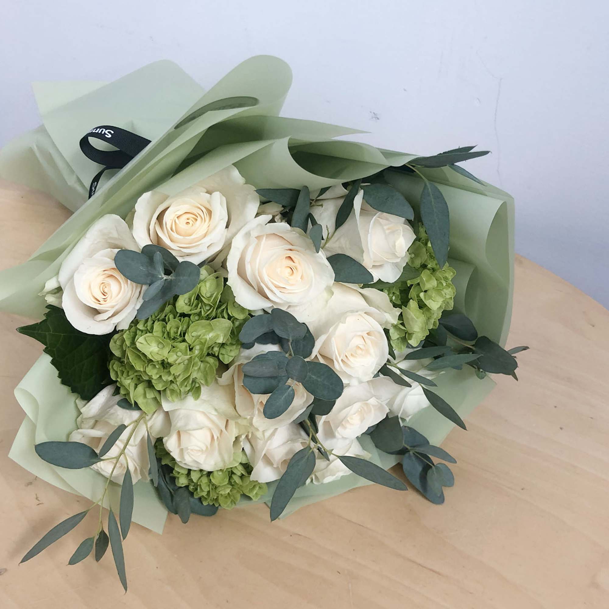 For romantic occasions, this beautifully wrapped handtied bouquet of 12 elegant white
