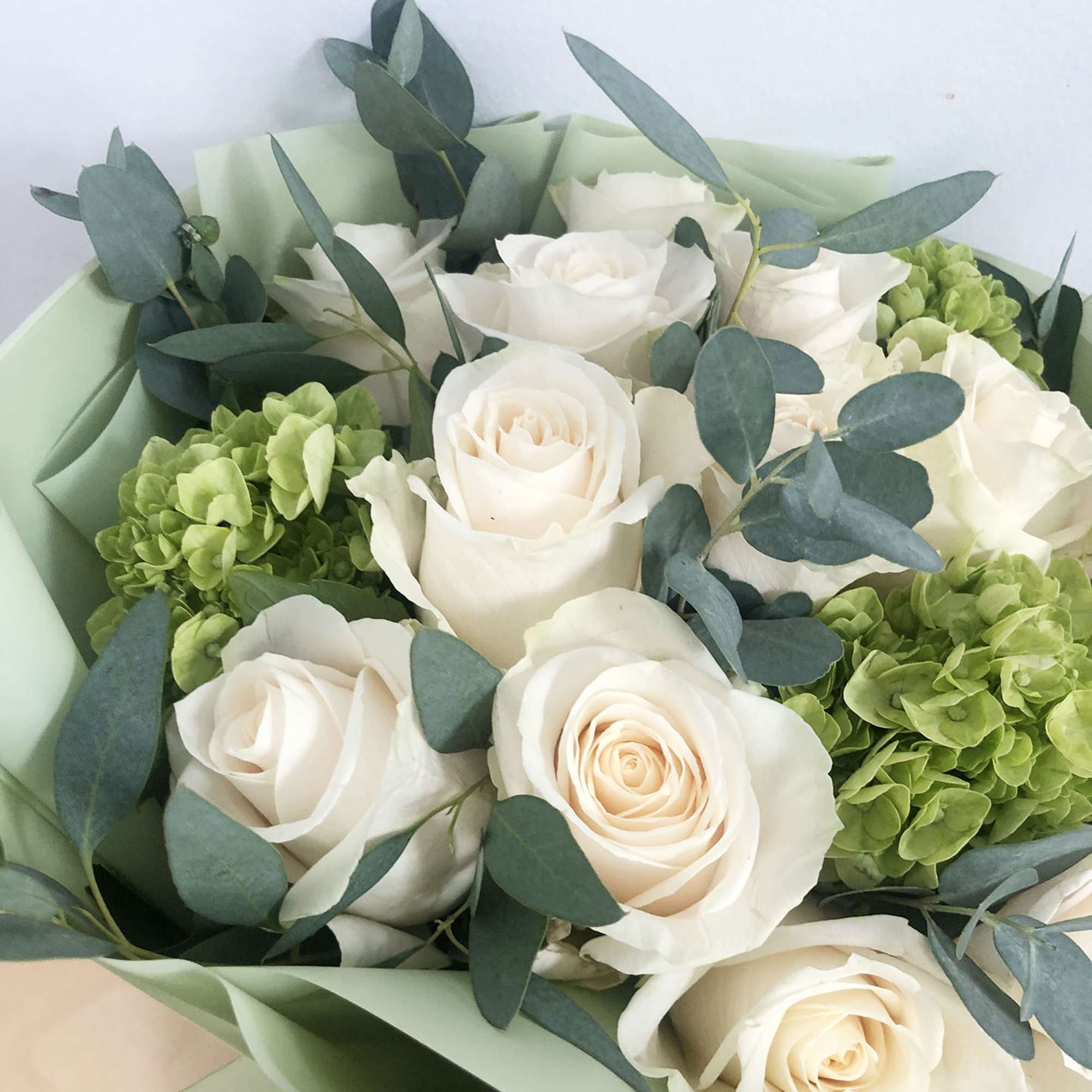 For romantic occasions, this beautifully wrapped handtied bouquet of 12 elegant white