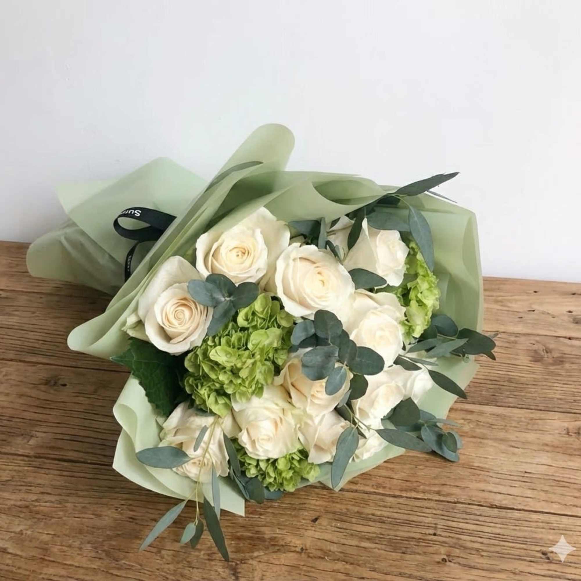 For romantic occasions, this beautifully wrapped handtied bouquet of 12 elegant white