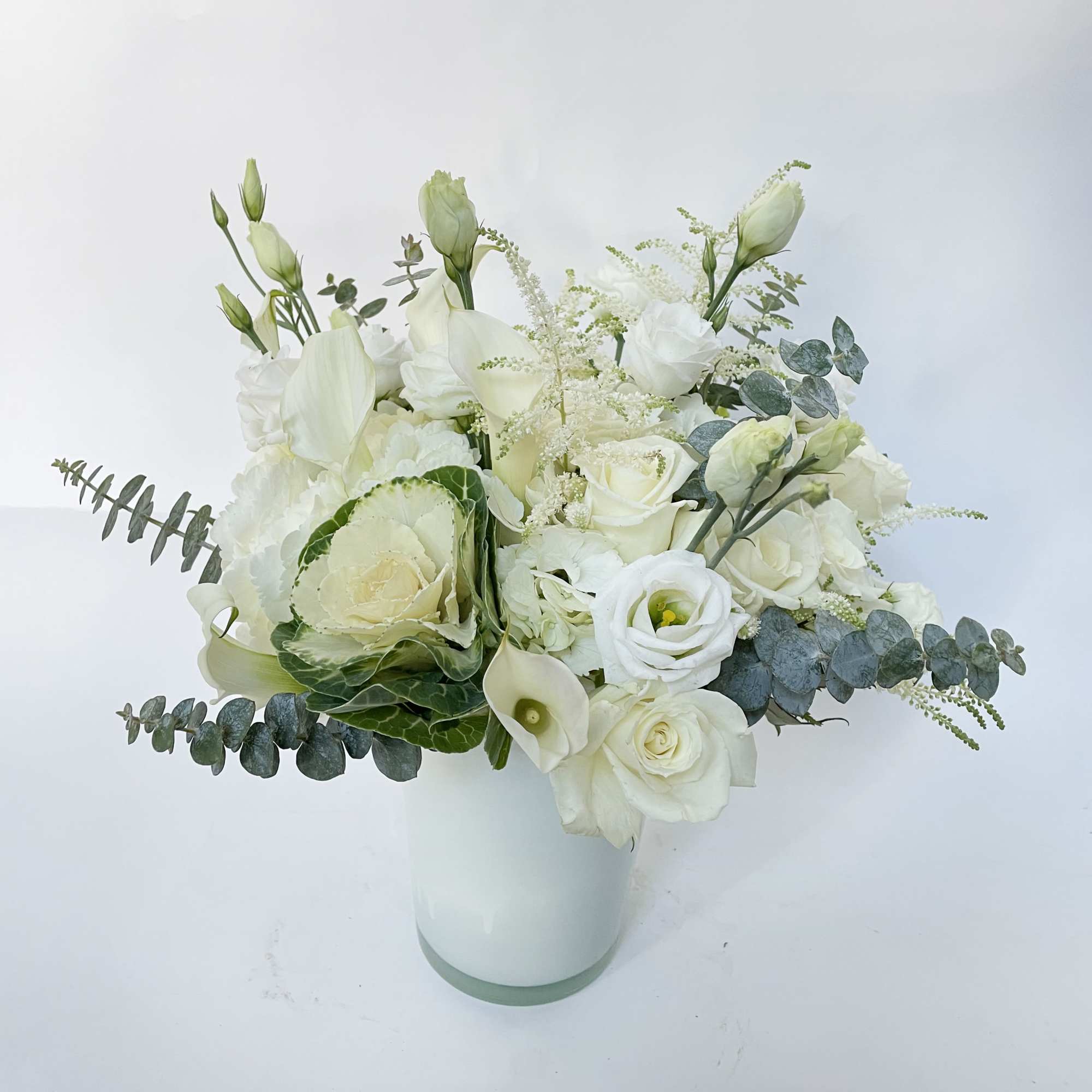 This white and green arrangement includes white hydrangeas, green hydrangeas, white roses
