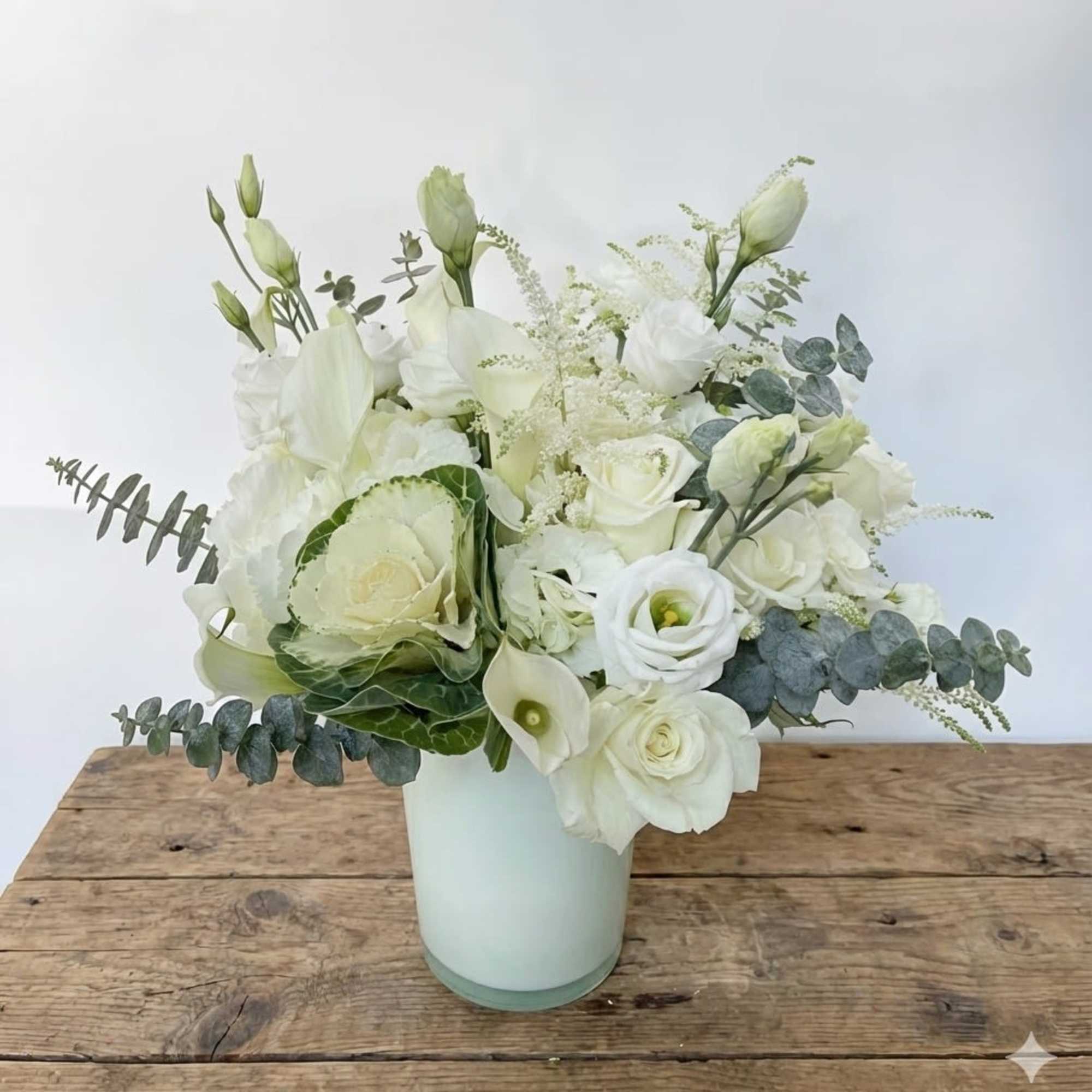 This white and green arrangement includes white hydrangeas, green hydrangeas, white roses