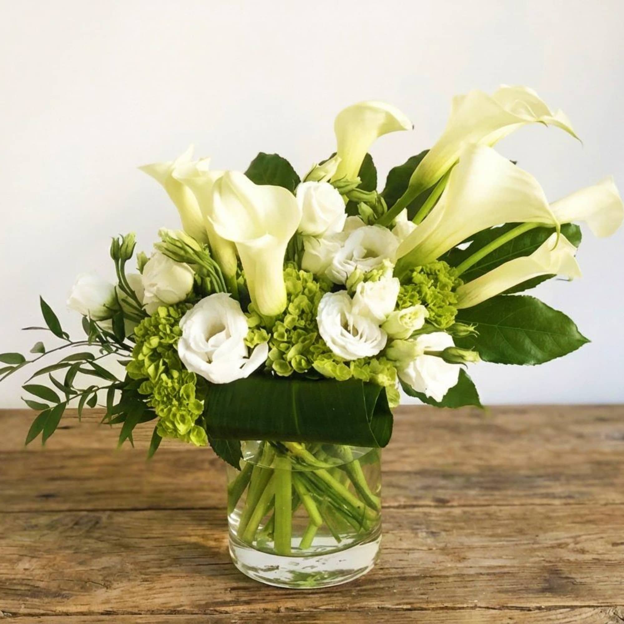 A very elegant design, featuring calla lily, white lisanthus and green hydrangea.