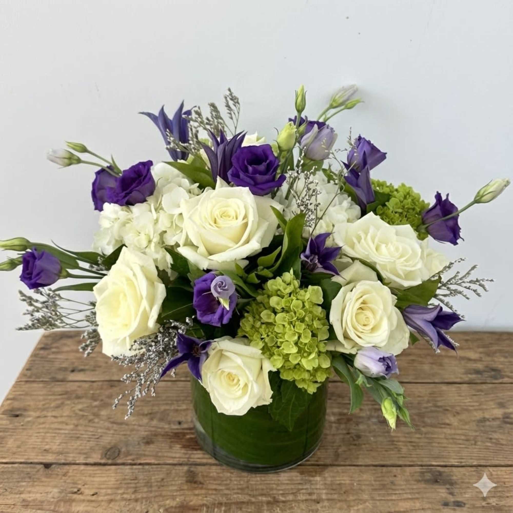 This arrangement is presented in 5"w*6"h clear cylinder vase, with green leaves