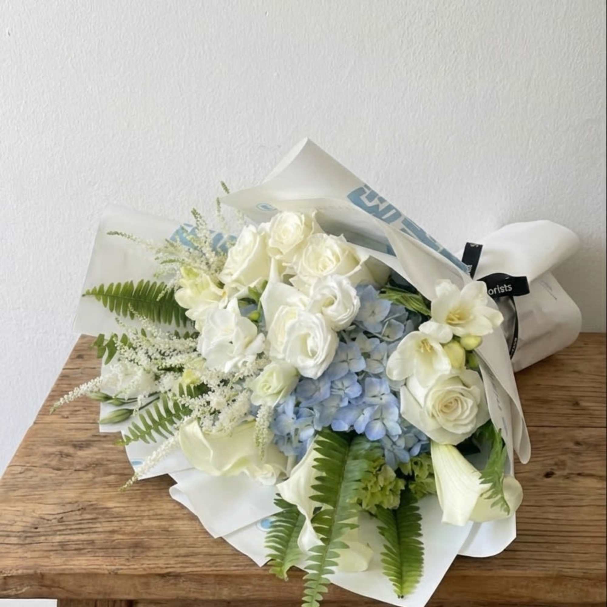 This bouquet features white and soft blue colors. 
