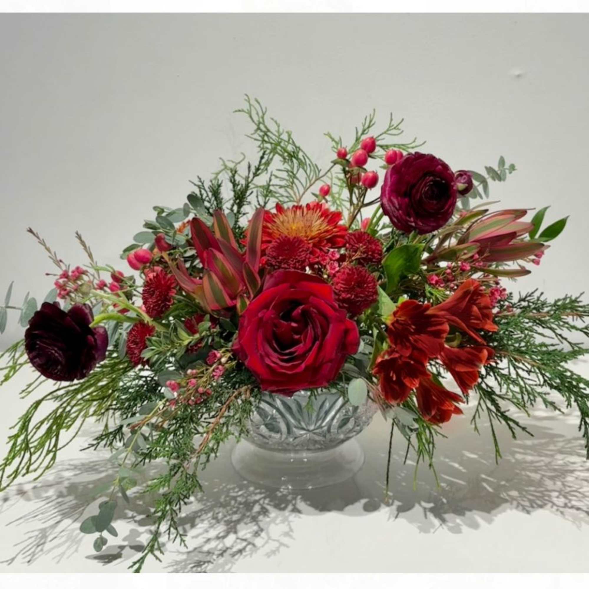 Celebrate the season with this luxurious Christmas centerpiece featuring heritage mums, leucadendron