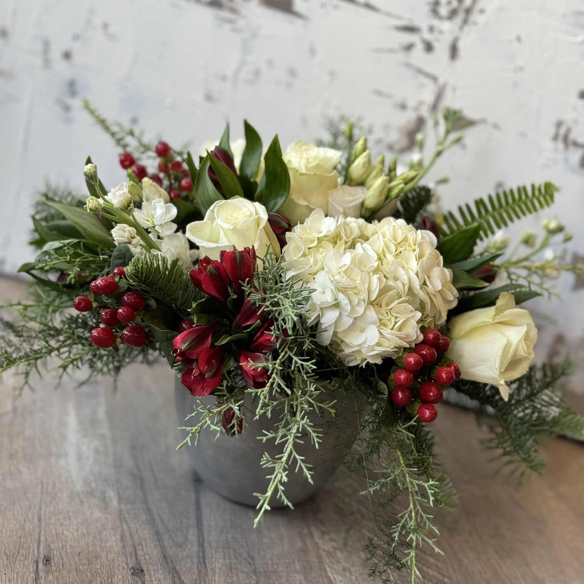 Blitzen&#039;s Berry Bliss is a festive arrangement that combines the vibrant colors