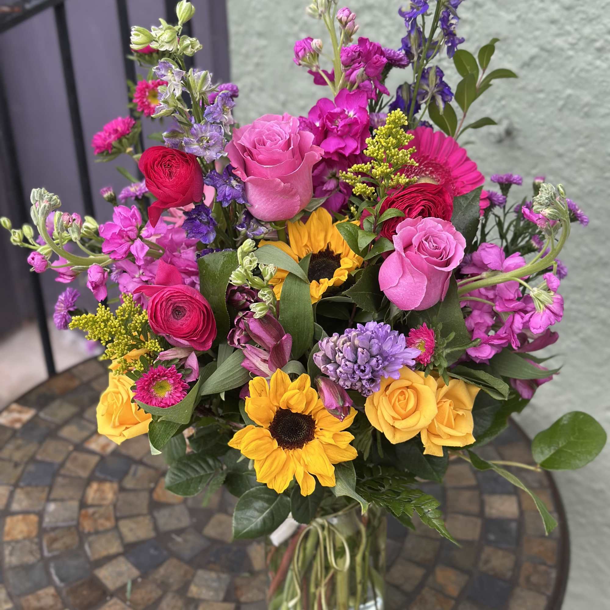 Beautiful happy flowers in array of bright colors, featuring mini sunflowers, larkspur