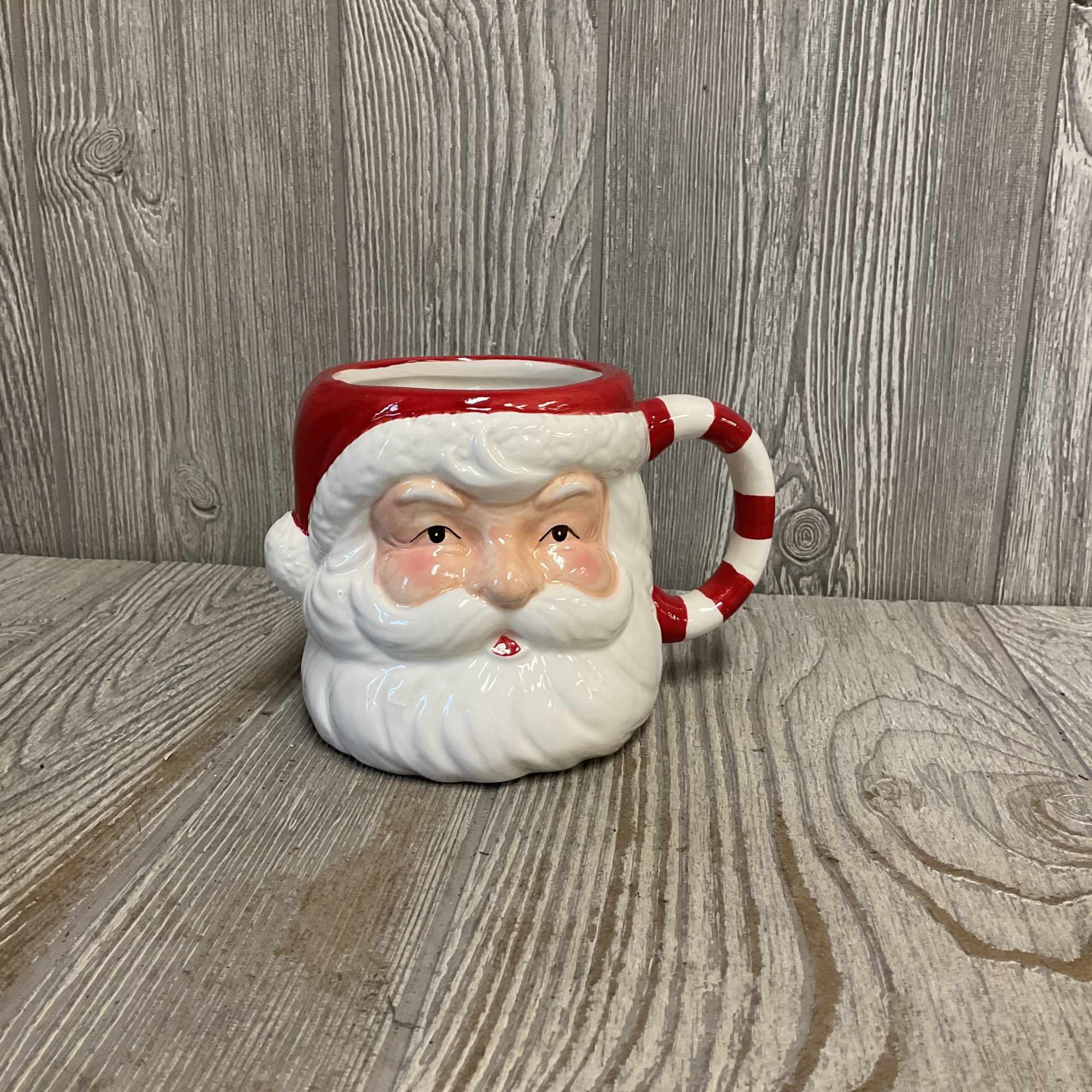 A cozy Christmas arrangement of roses, carnations, pine and greenery in a